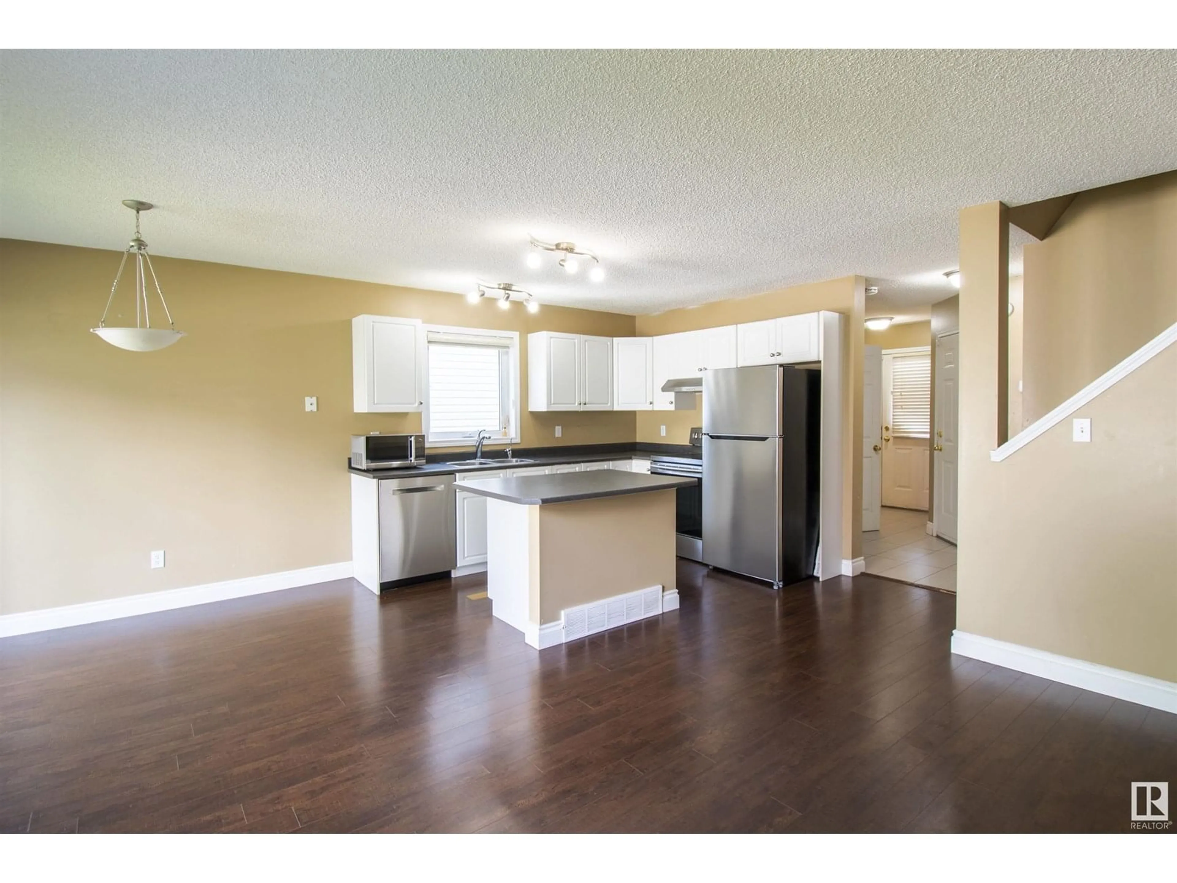 Open concept kitchen, wood/laminate floor for #34 - 4020 21 ST, Edmonton Alberta T6T1T8