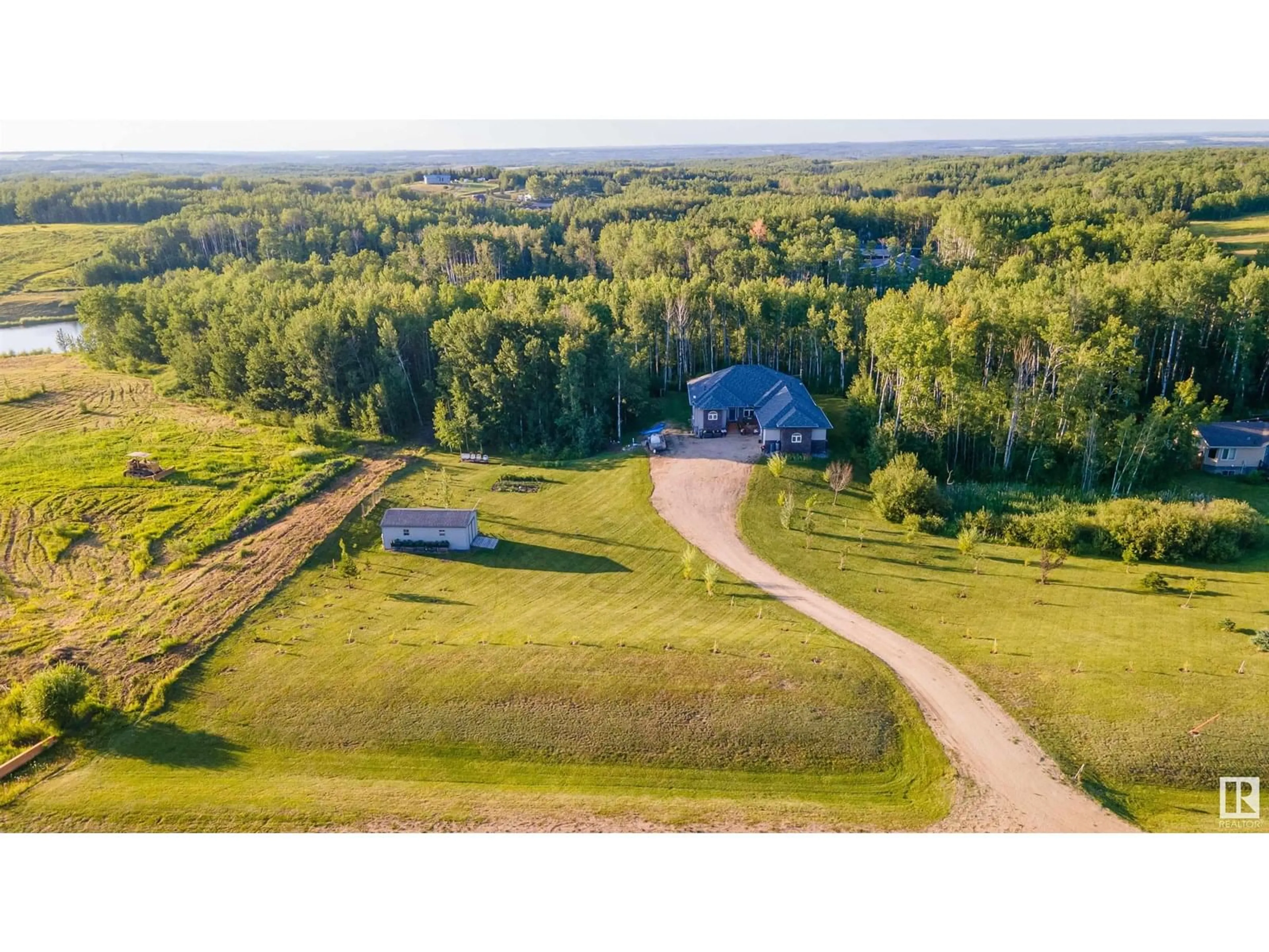 A pic from outside/outdoor area/front of a property/back of a property/a pic from drone, water/lake/river/ocean view for #4 - 54208 RGE ROAD 12, Rural Lac Ste. Anne County Alberta T0E1V2