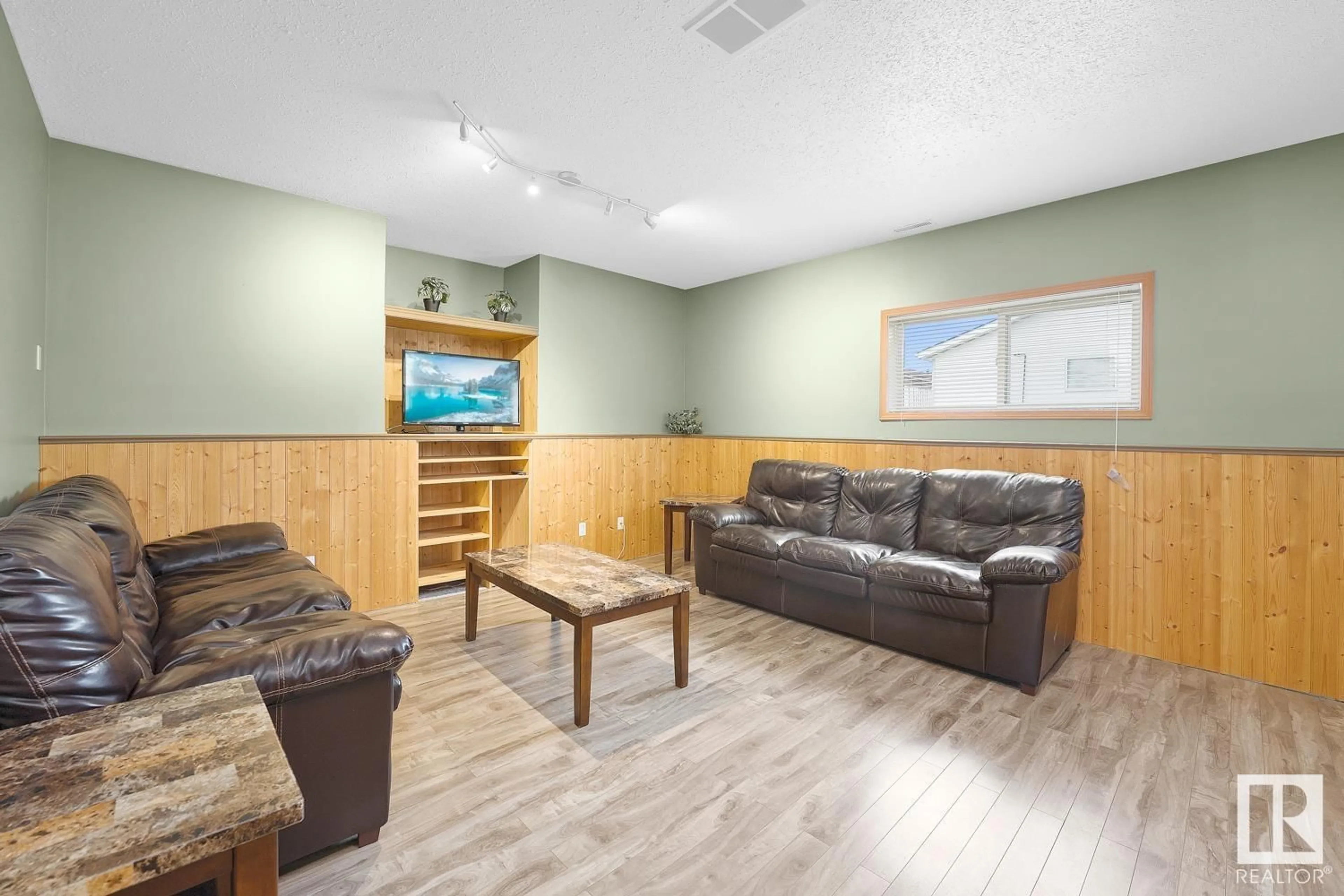 Living room with furniture, wood/laminate floor for 4104 50 AV, Bonnyville Town Alberta T9N1C4