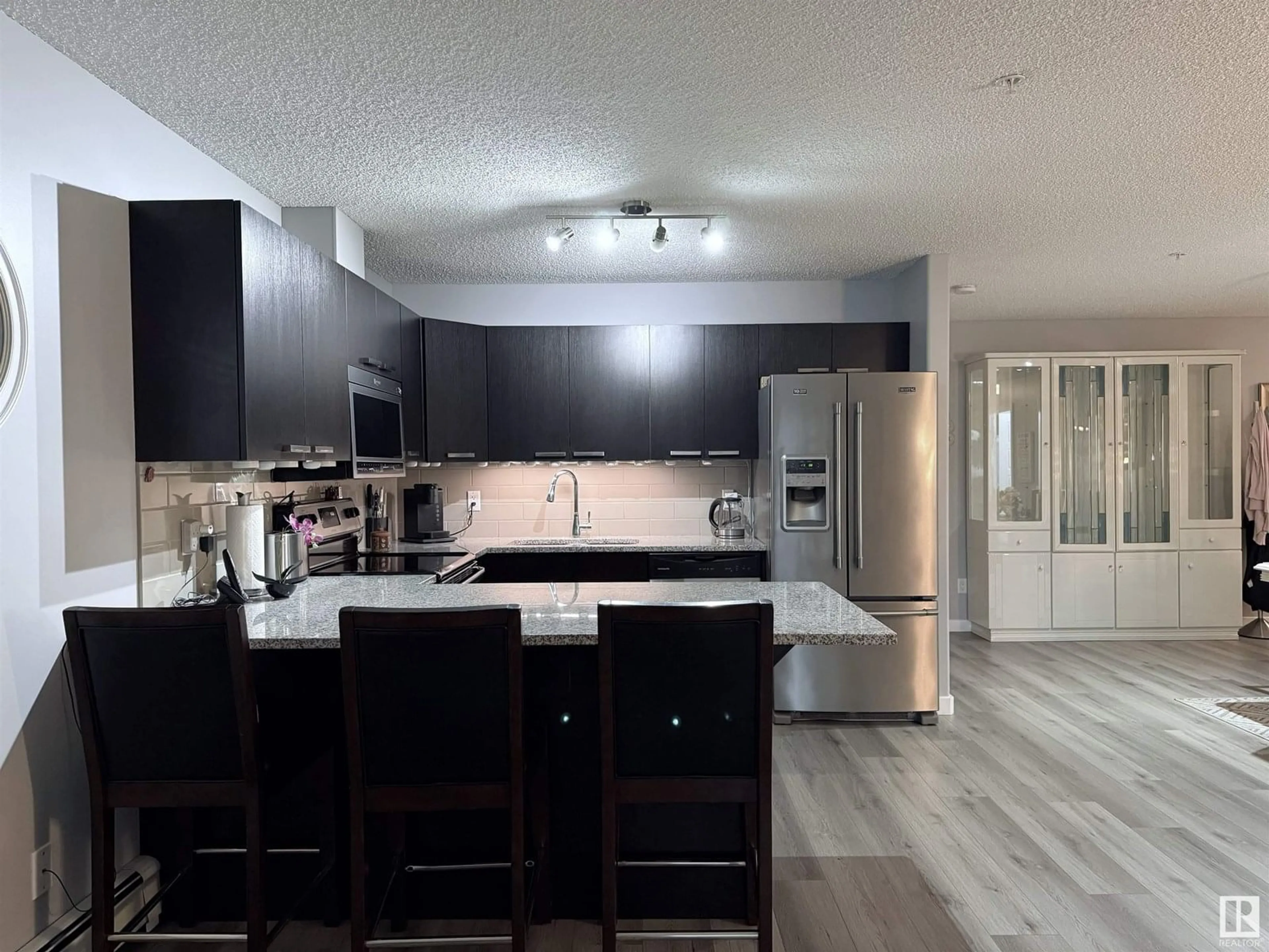 Open concept kitchen, wood/laminate floor for #104 - 14808 125 ST, Edmonton Alberta T5X0G1