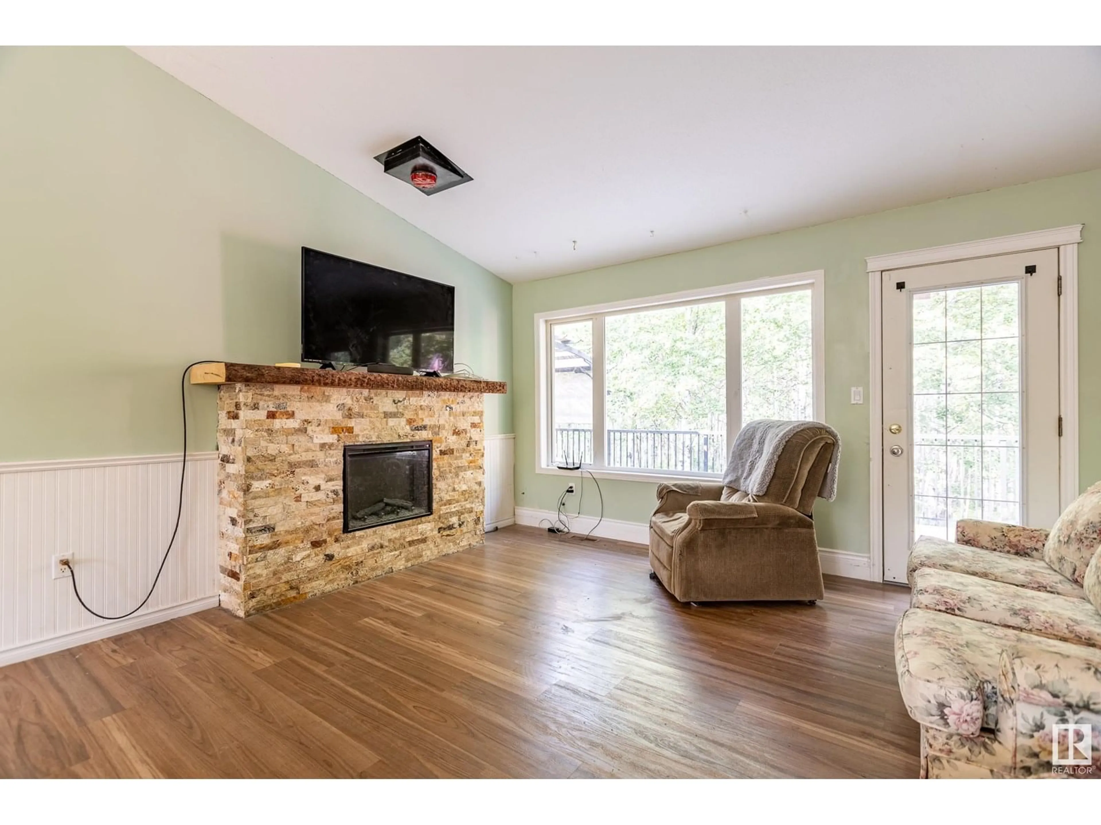 Living room with furniture, wood/laminate floor for 28 BELLA VISTA ES, Rural Lac Ste. Anne County Alberta T0E1N0