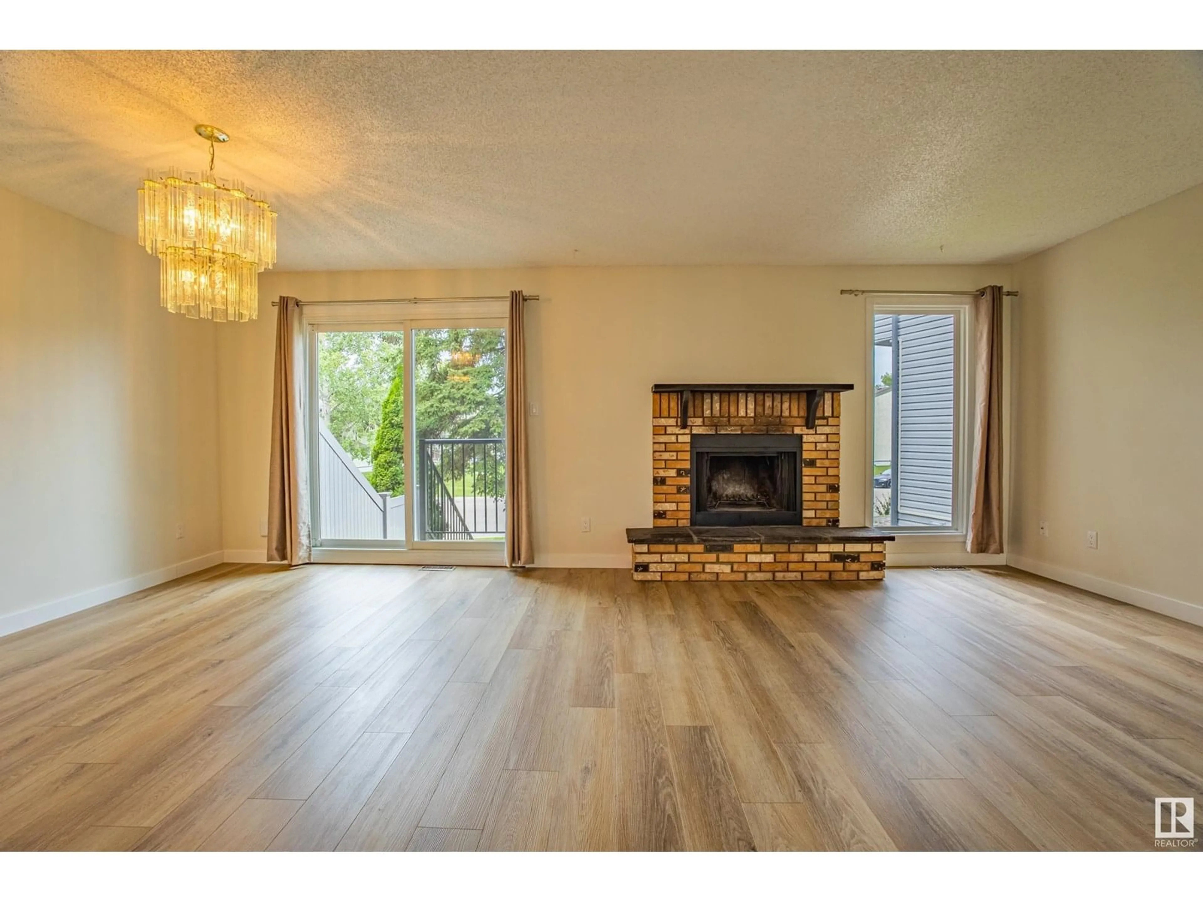 Living room with furniture, wood/laminate floor for 5388 38A AV, Edmonton Alberta T6L2H4