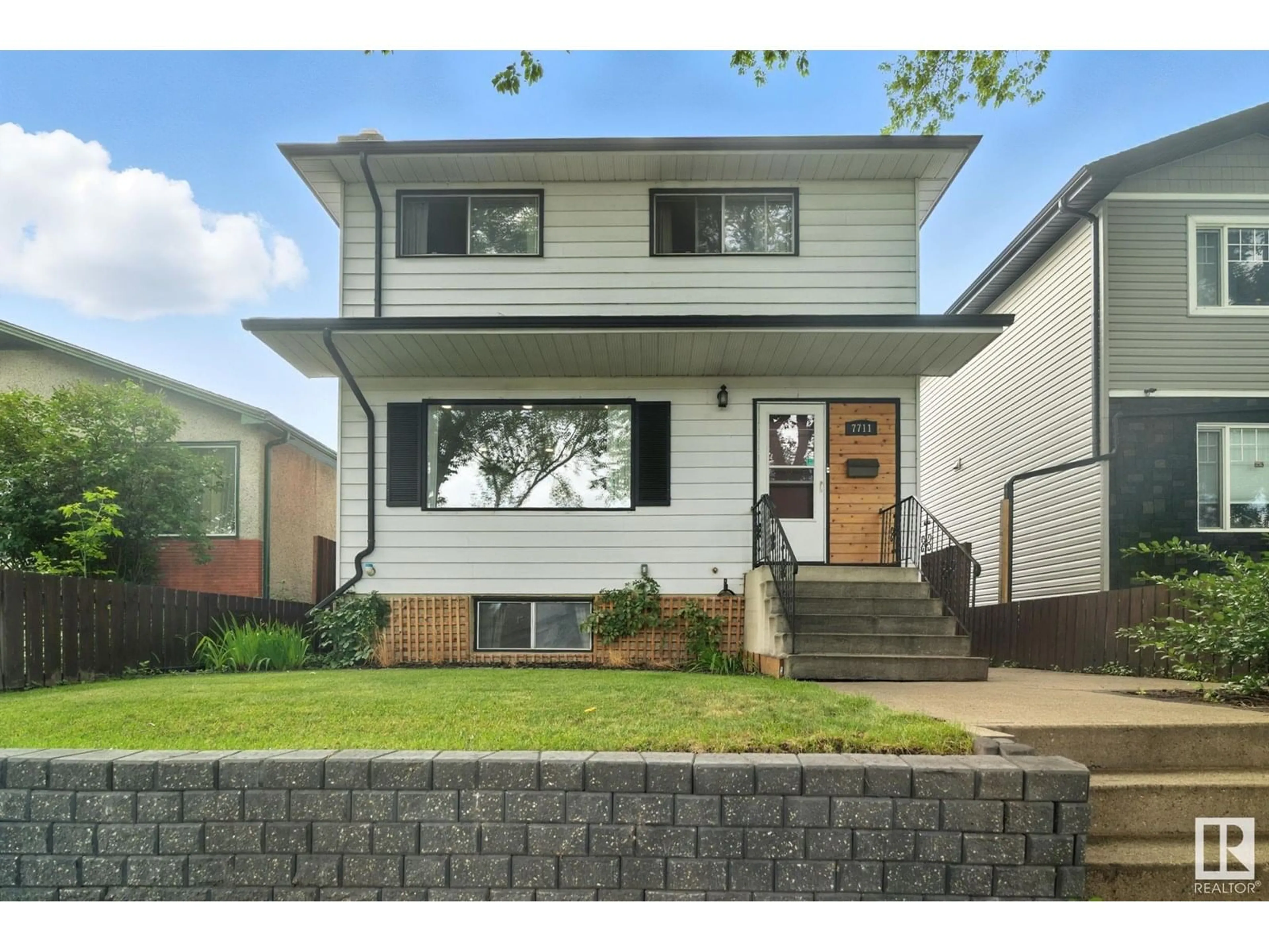 Home with brick exterior material, street for 7711 80 AV, Edmonton Alberta T6C0S3
