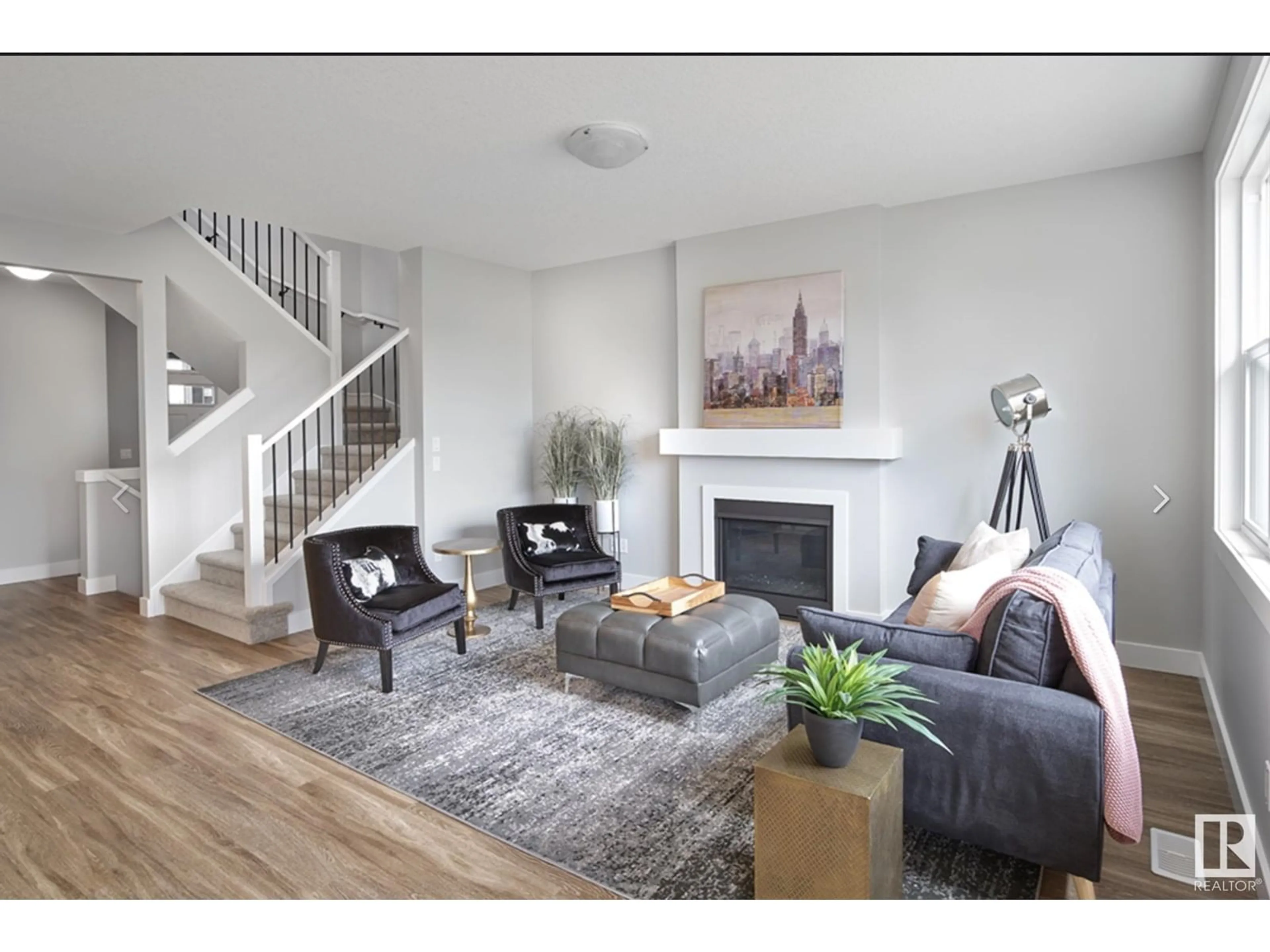 Living room with furniture, wood/laminate floor for NW - 8019 228 ST, Edmonton Alberta T5T7X8