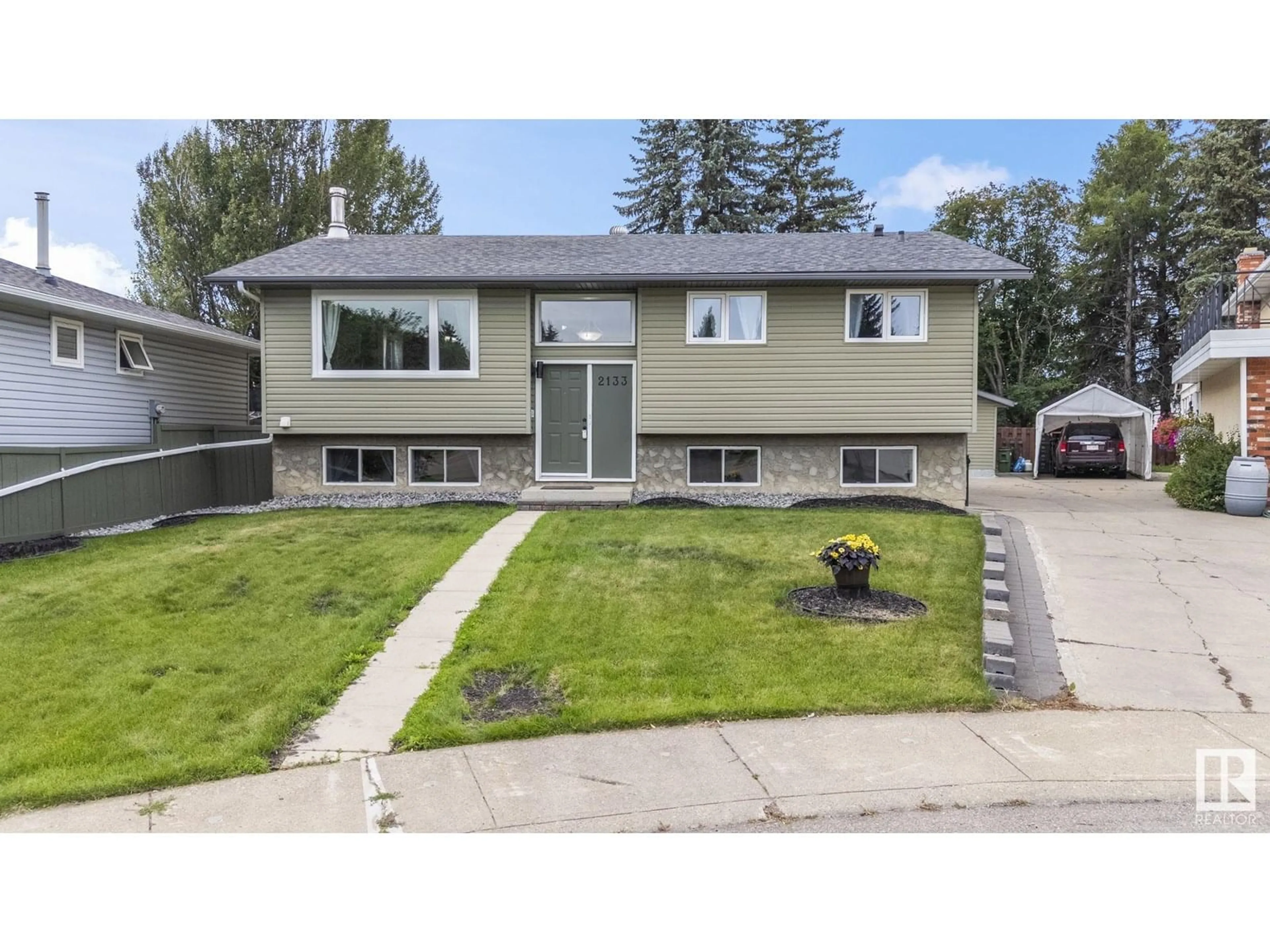 Home with vinyl exterior material, street for NW - 2133 85 ST, Edmonton Alberta T6K2G1