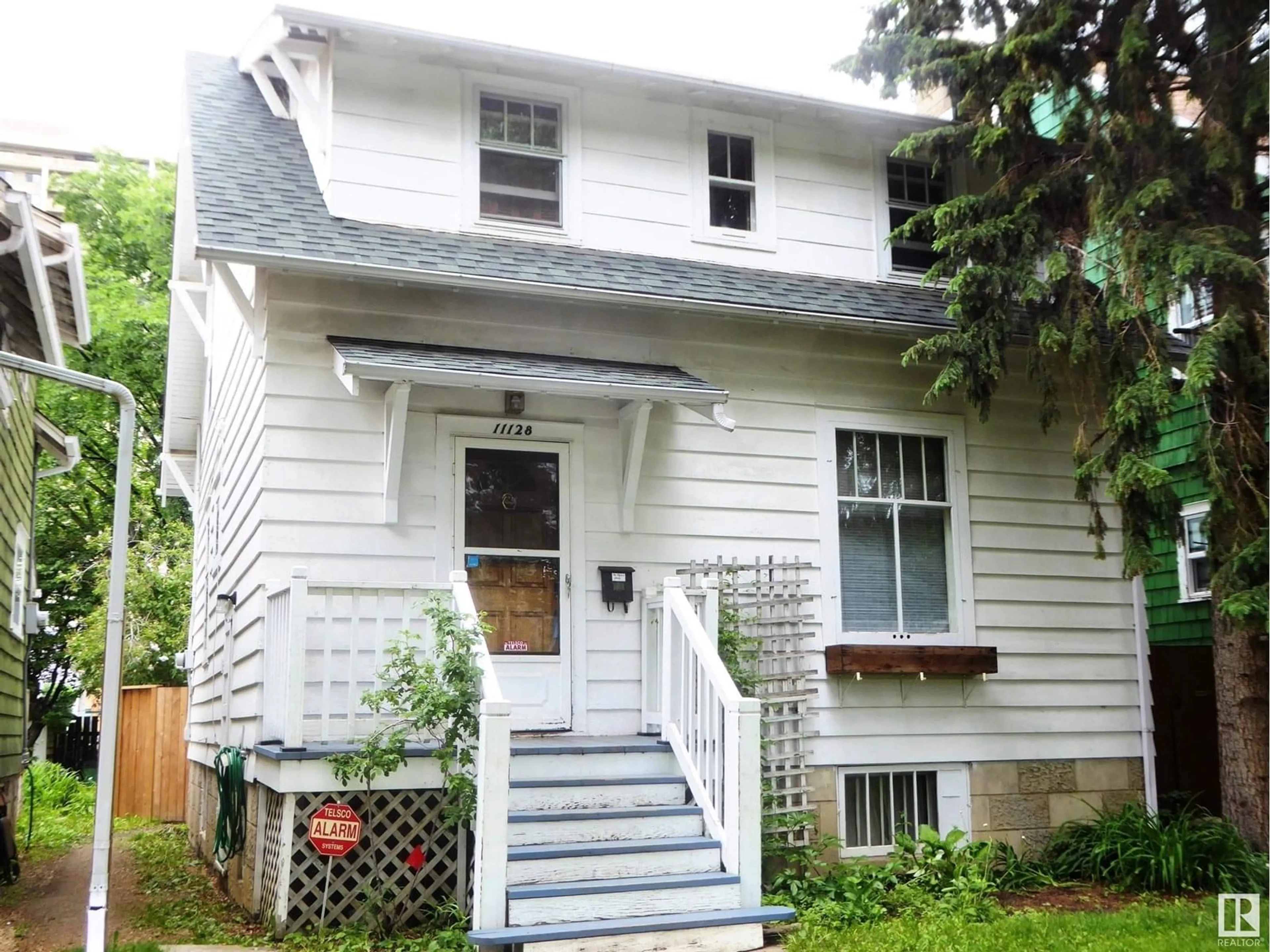 Home with vinyl exterior material, street for 11128 81 AV, Edmonton Alberta T6G0S5