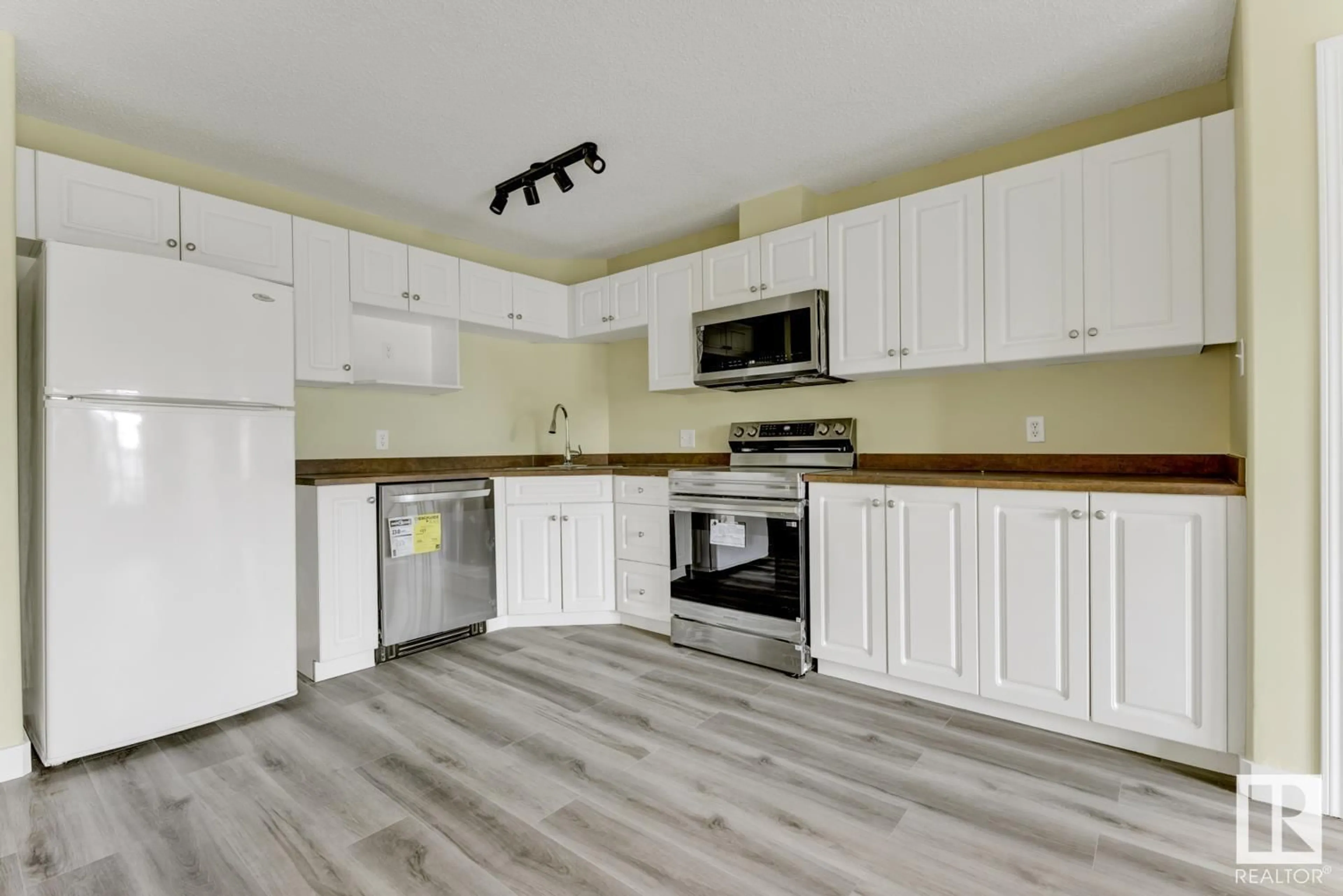Open concept kitchen, wood/laminate floor for #214 - 111 EDWARDS DR, Edmonton Alberta T5X1G2