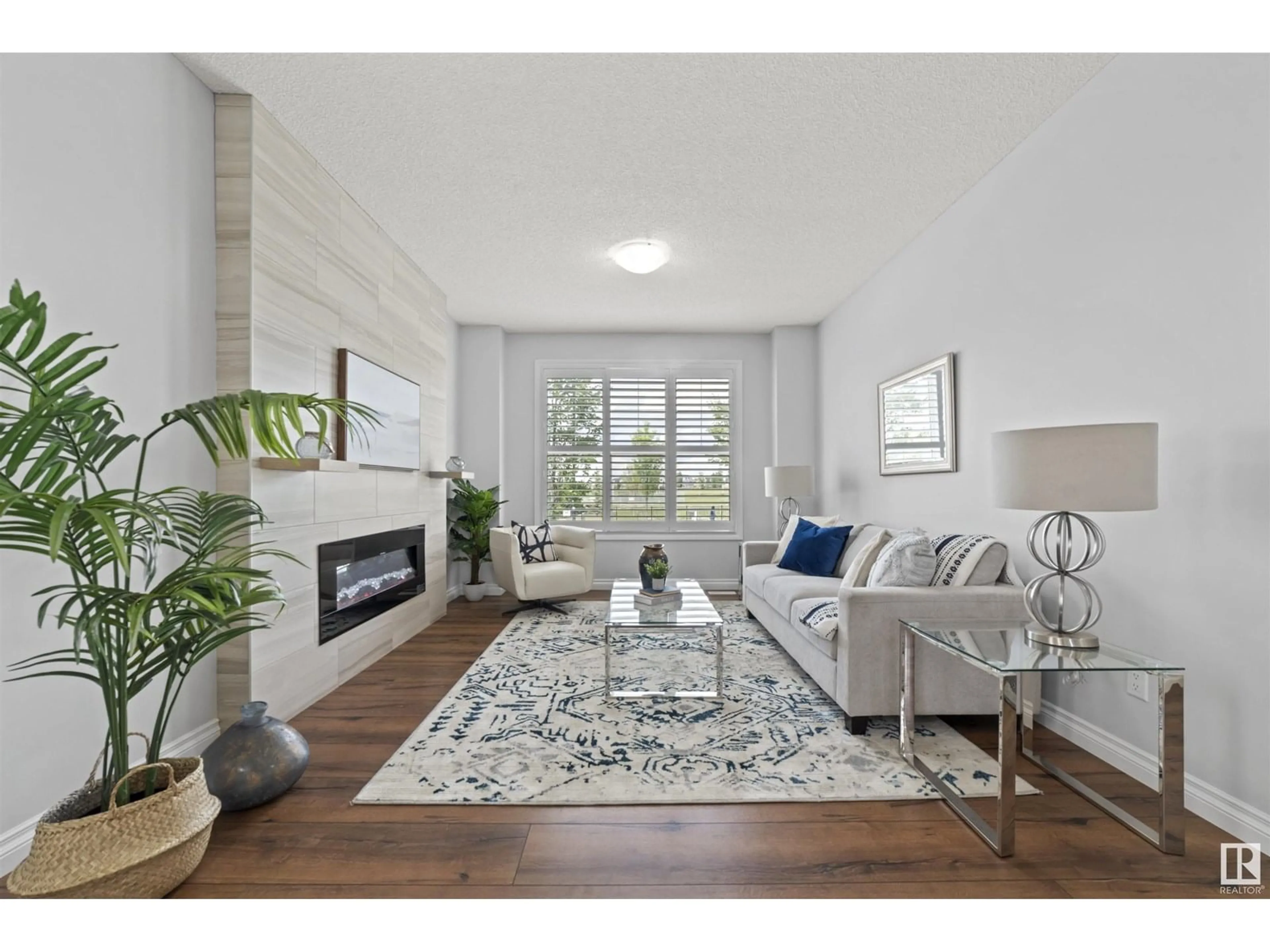 Living room with furniture, wood/laminate floor for 8079 CHAPPELLE WY, Edmonton Alberta T6W3L7