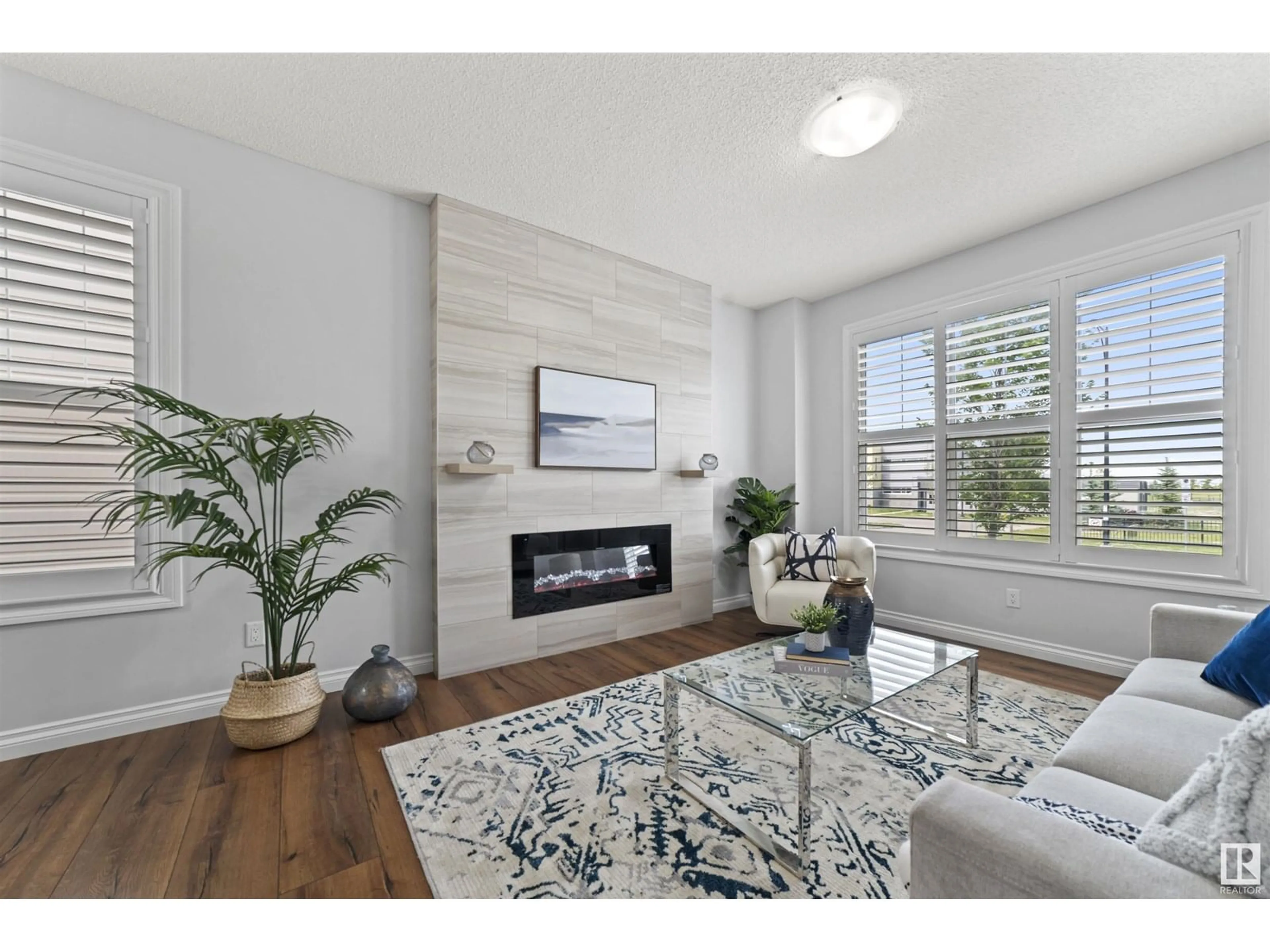 Living room with furniture, wood/laminate floor for 8079 CHAPPELLE WY, Edmonton Alberta T6W3L7