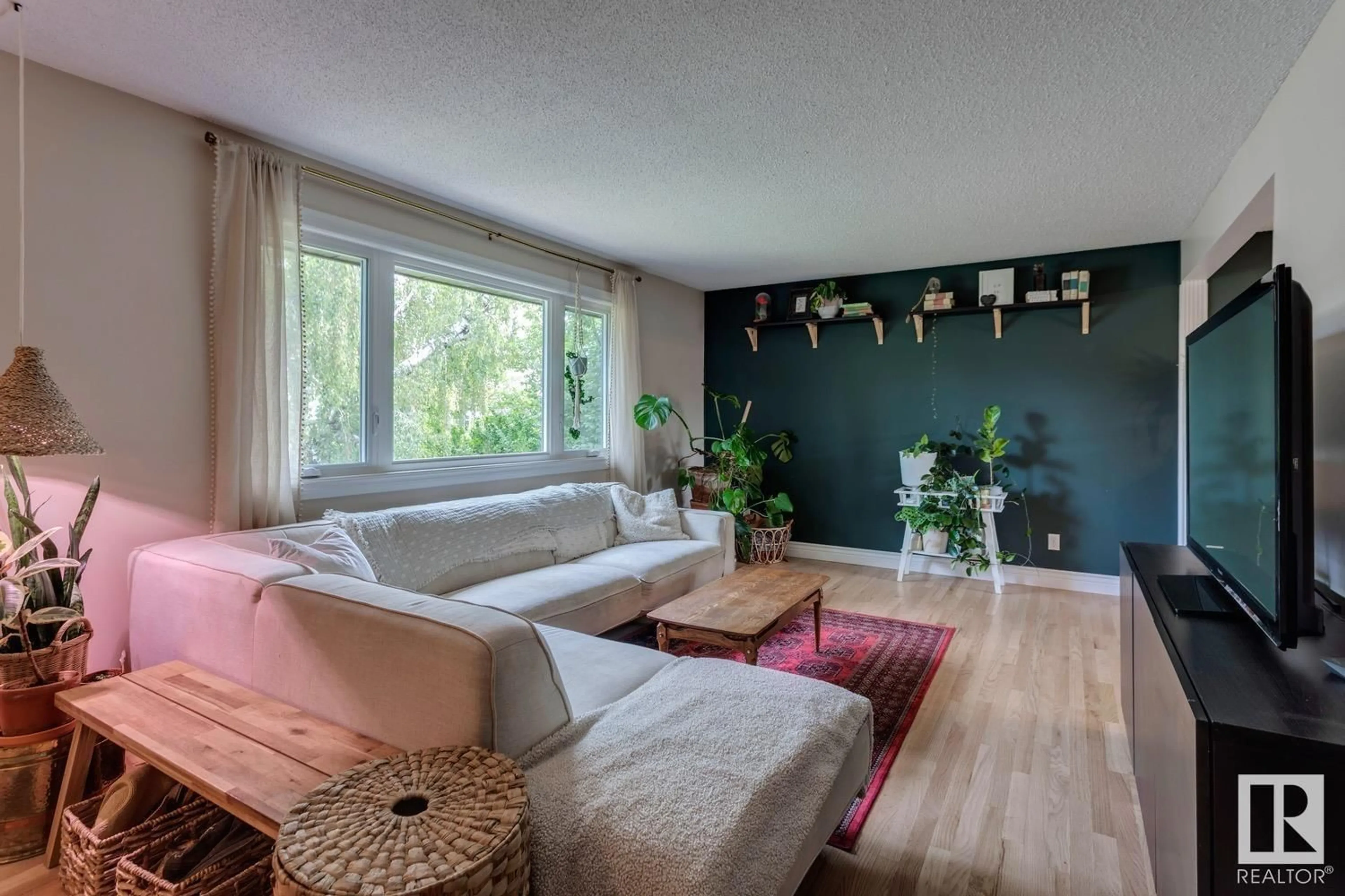 Living room with furniture, wood/laminate floor for 16115 90 AV, Edmonton Alberta T5R4W7