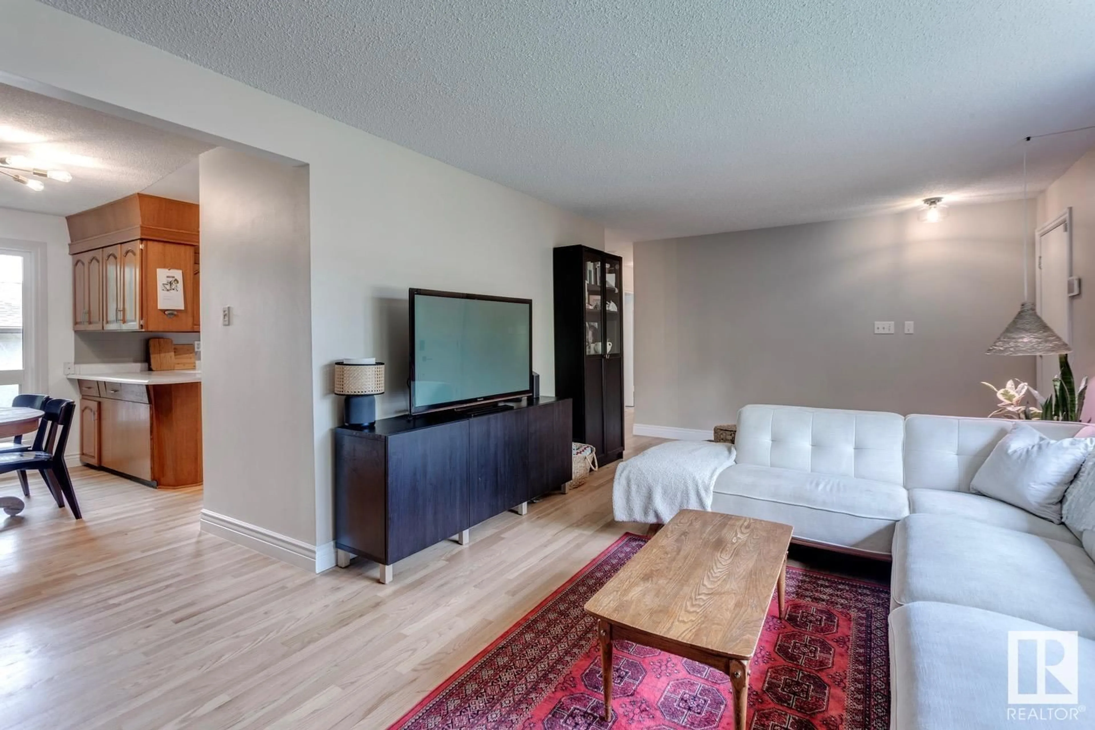 Living room with furniture, wood/laminate floor for 16115 90 AV, Edmonton Alberta T5R4W7