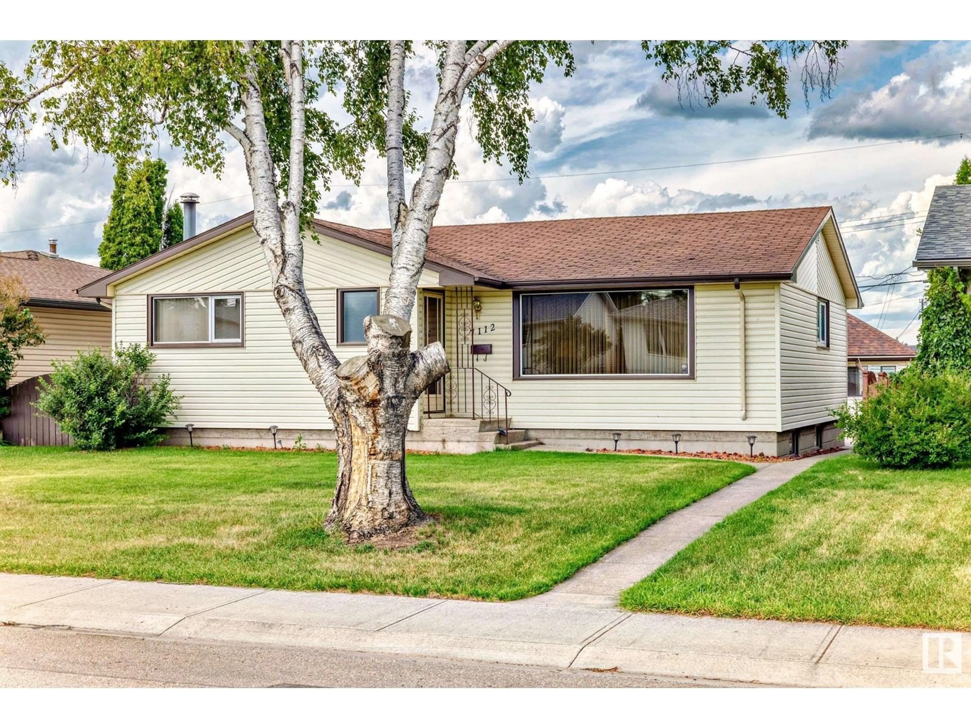 Home with vinyl exterior material, street for 7112 99 AV, Edmonton Alberta T6A0E1