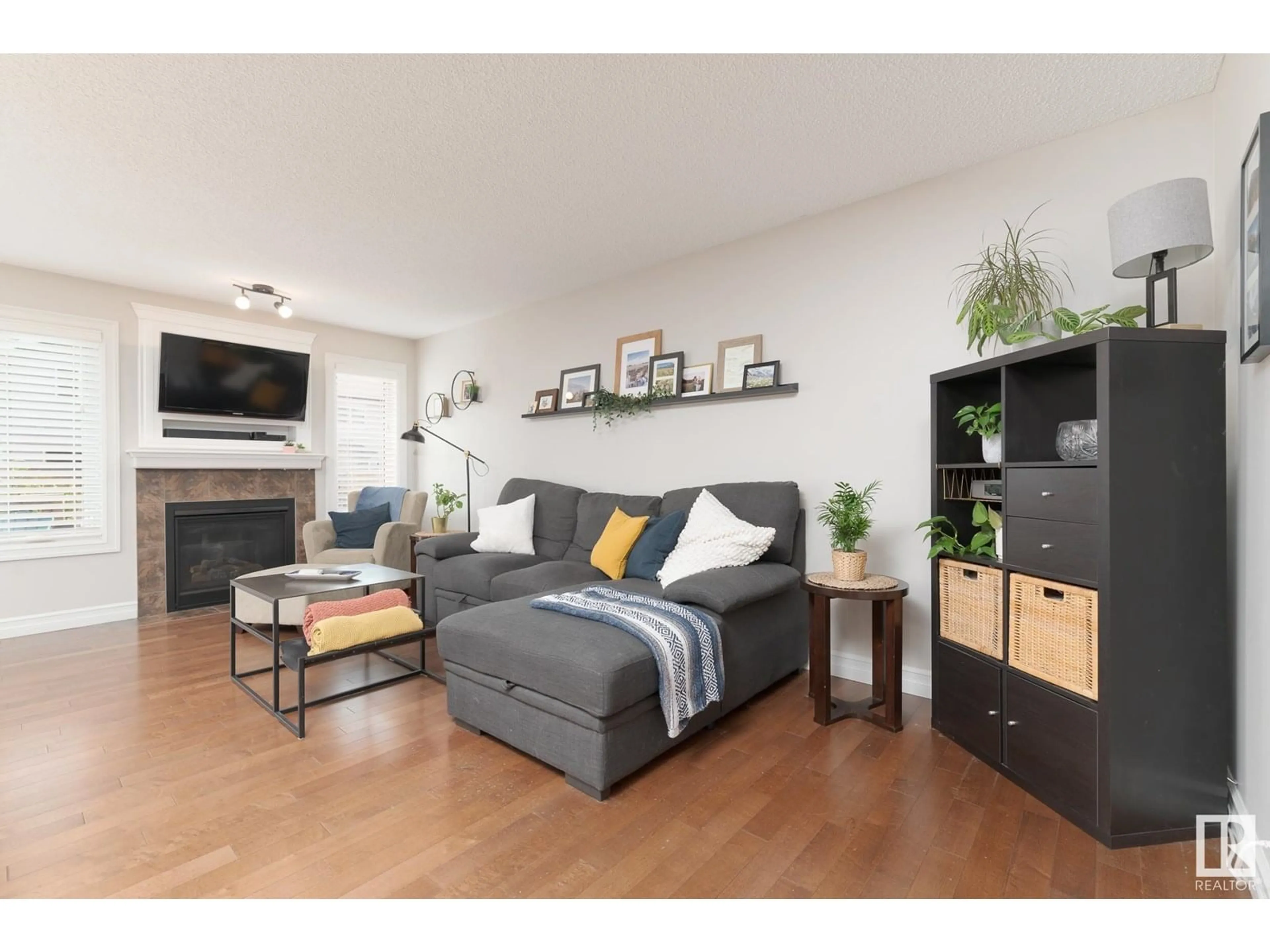 Living room with furniture, wood/laminate floor for 3013 16A AV, Edmonton Alberta T6T0P8