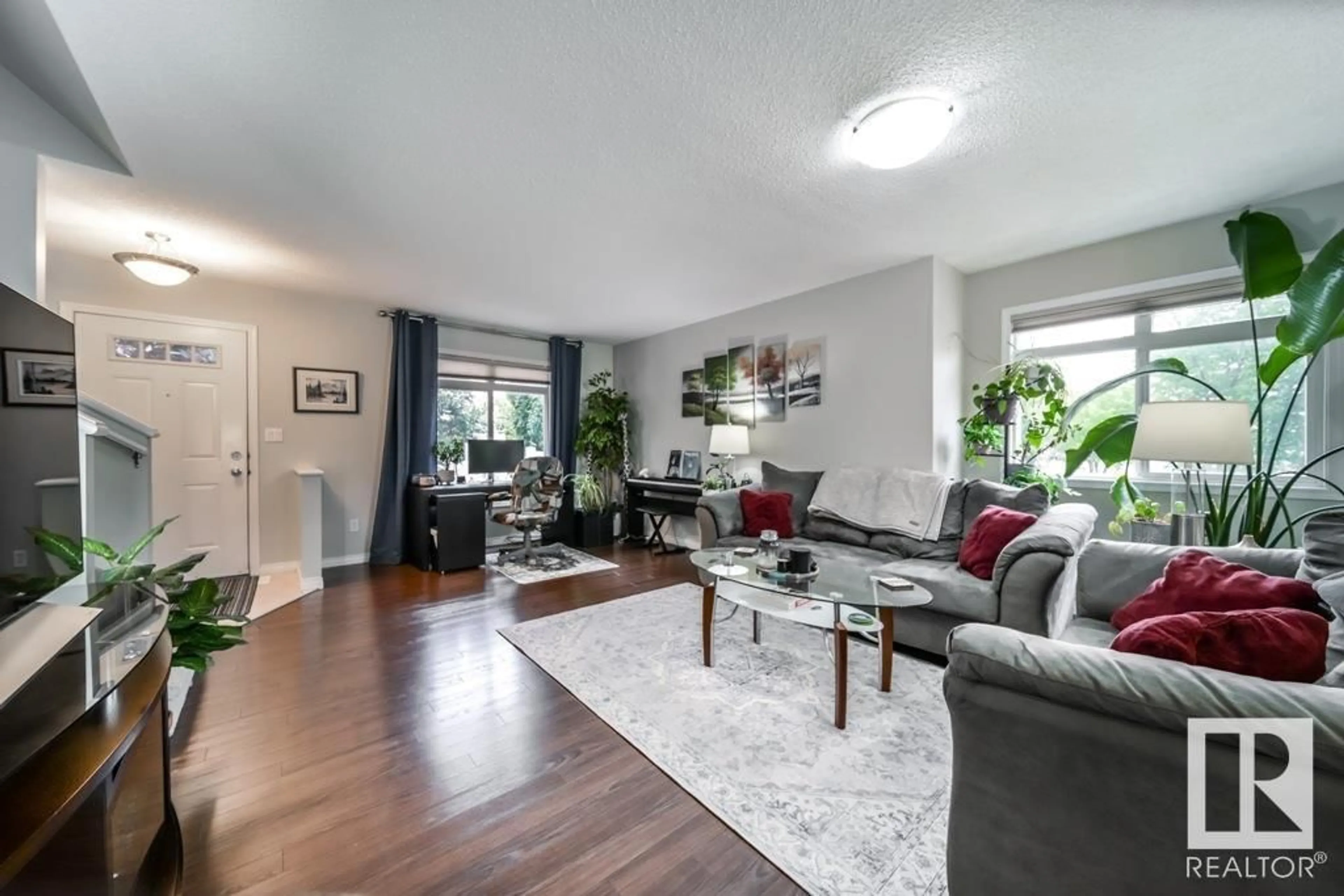 Living room with furniture, wood/laminate floor for 191 1804 70 ST SW, Edmonton Alberta T6X0H4