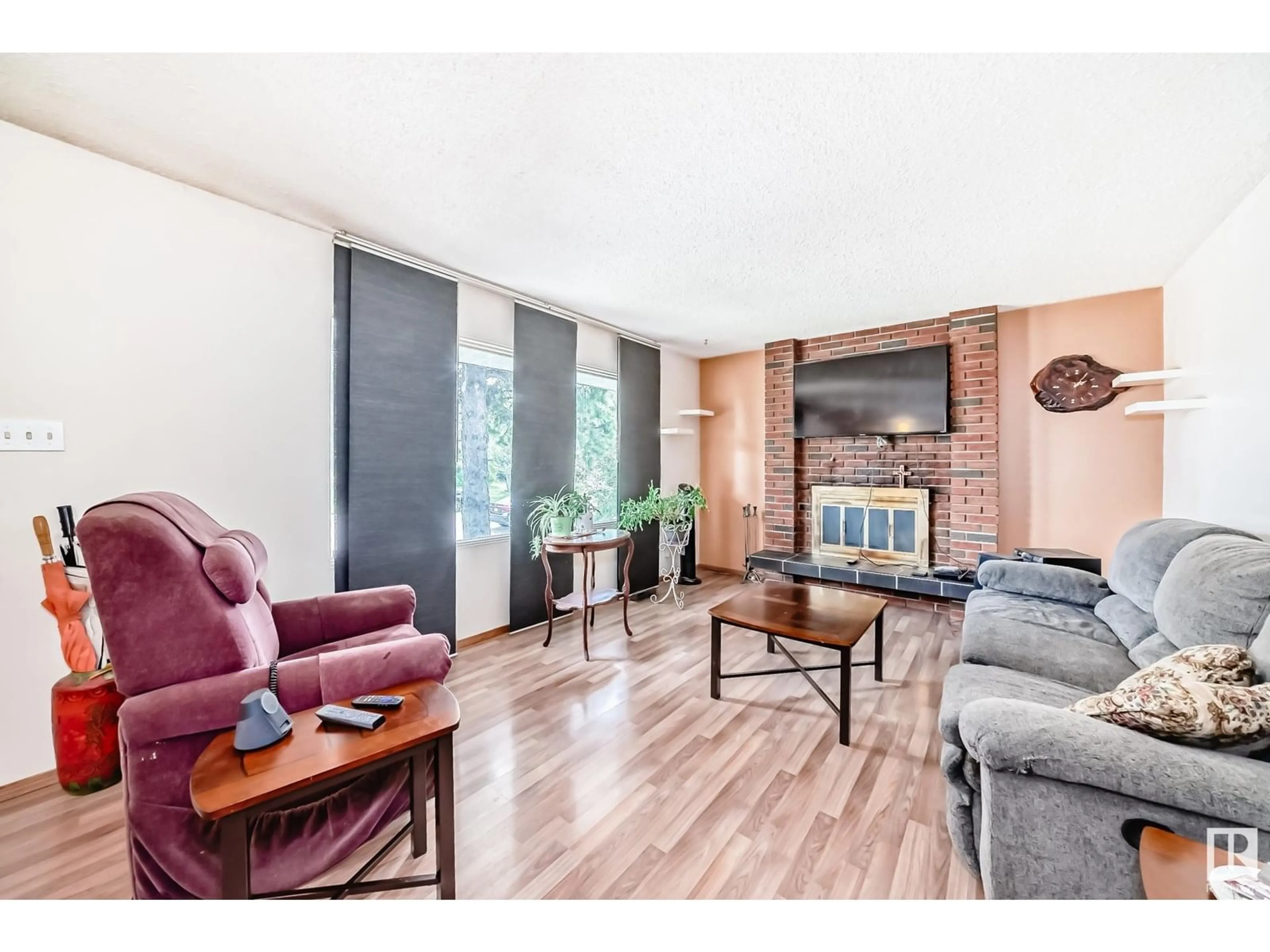 Living room with furniture, wood/laminate floor for 7820 22 ST, Edmonton Alberta T6K2E3