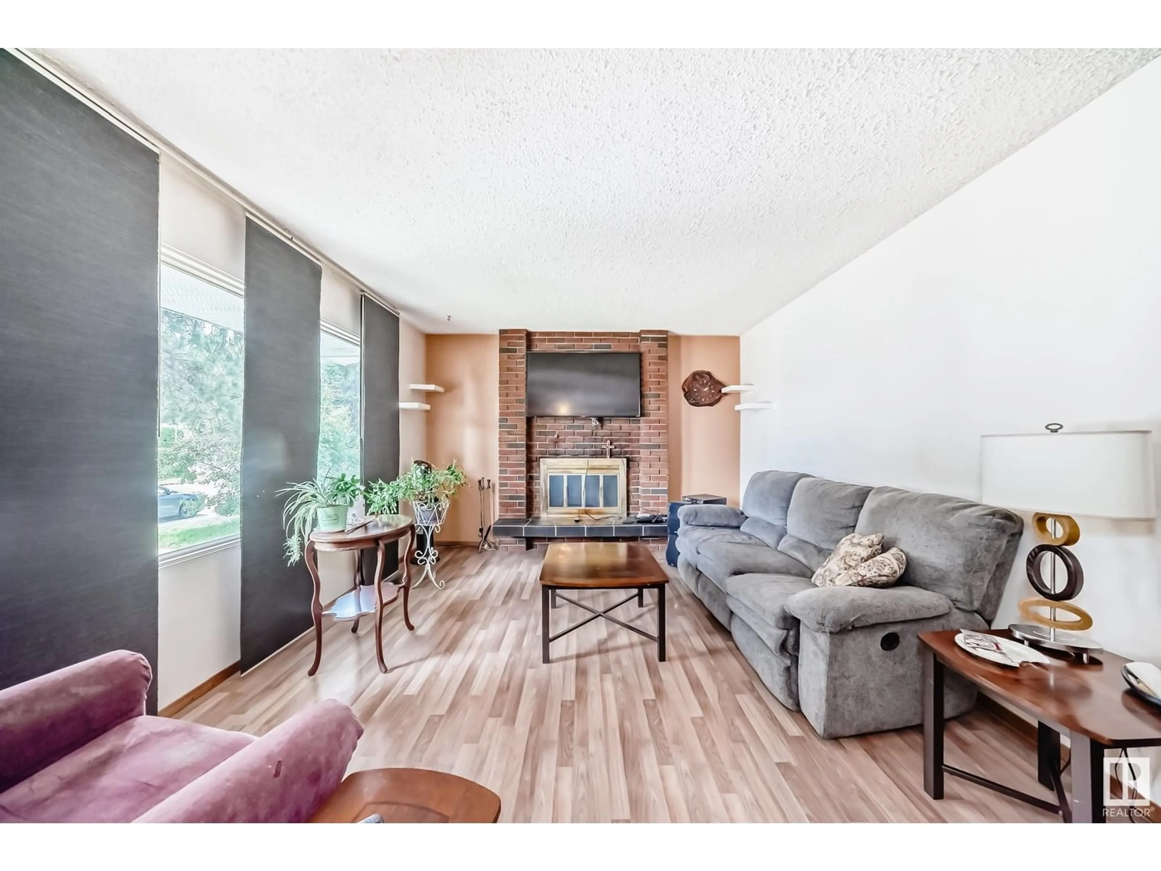 Living room with furniture, wood/laminate floor for 7820 22 ST, Edmonton Alberta T6K2E3