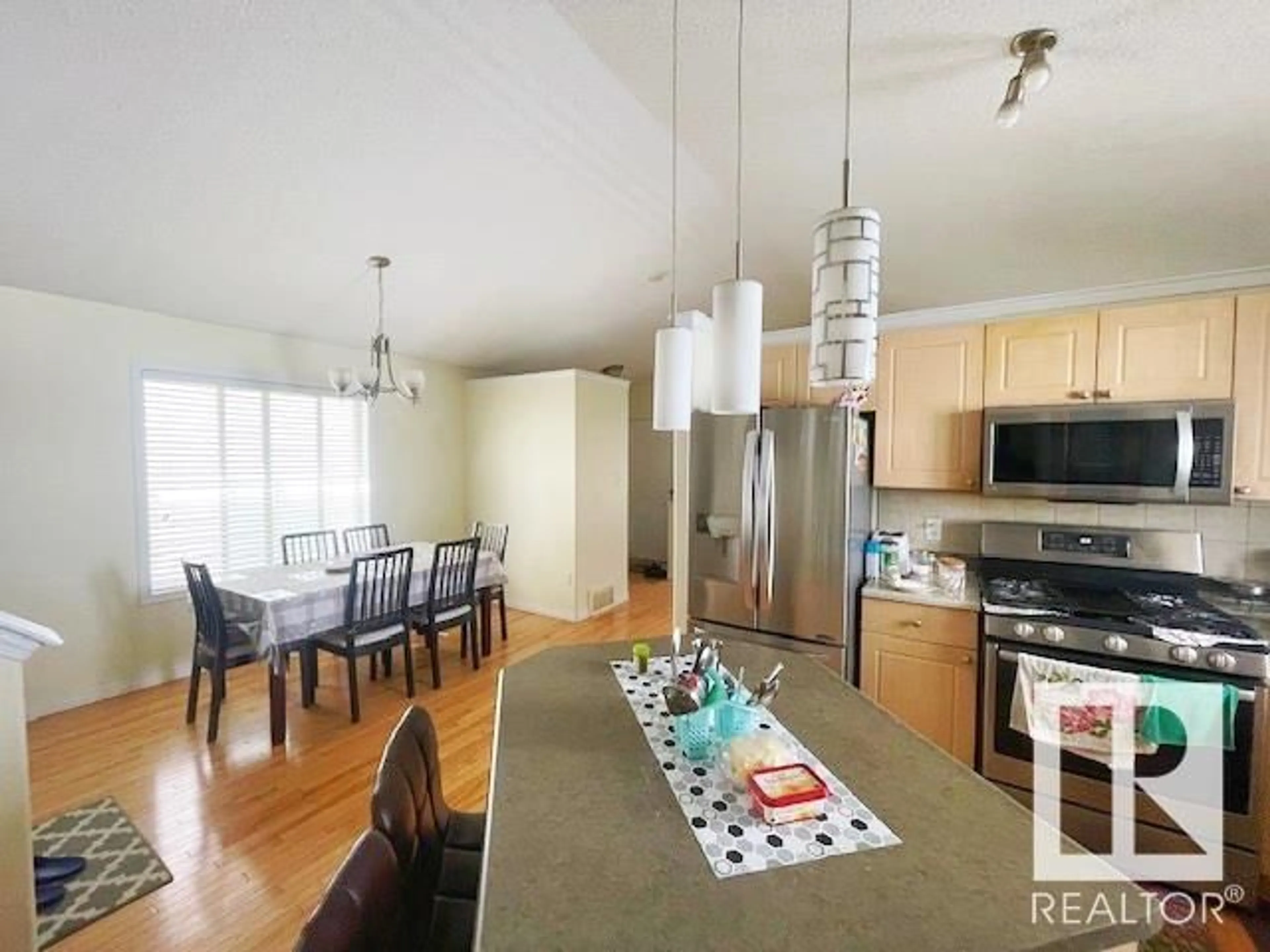 Open concept kitchen, wood/laminate floor for 613 83 ST, Edmonton Alberta T6X1L6