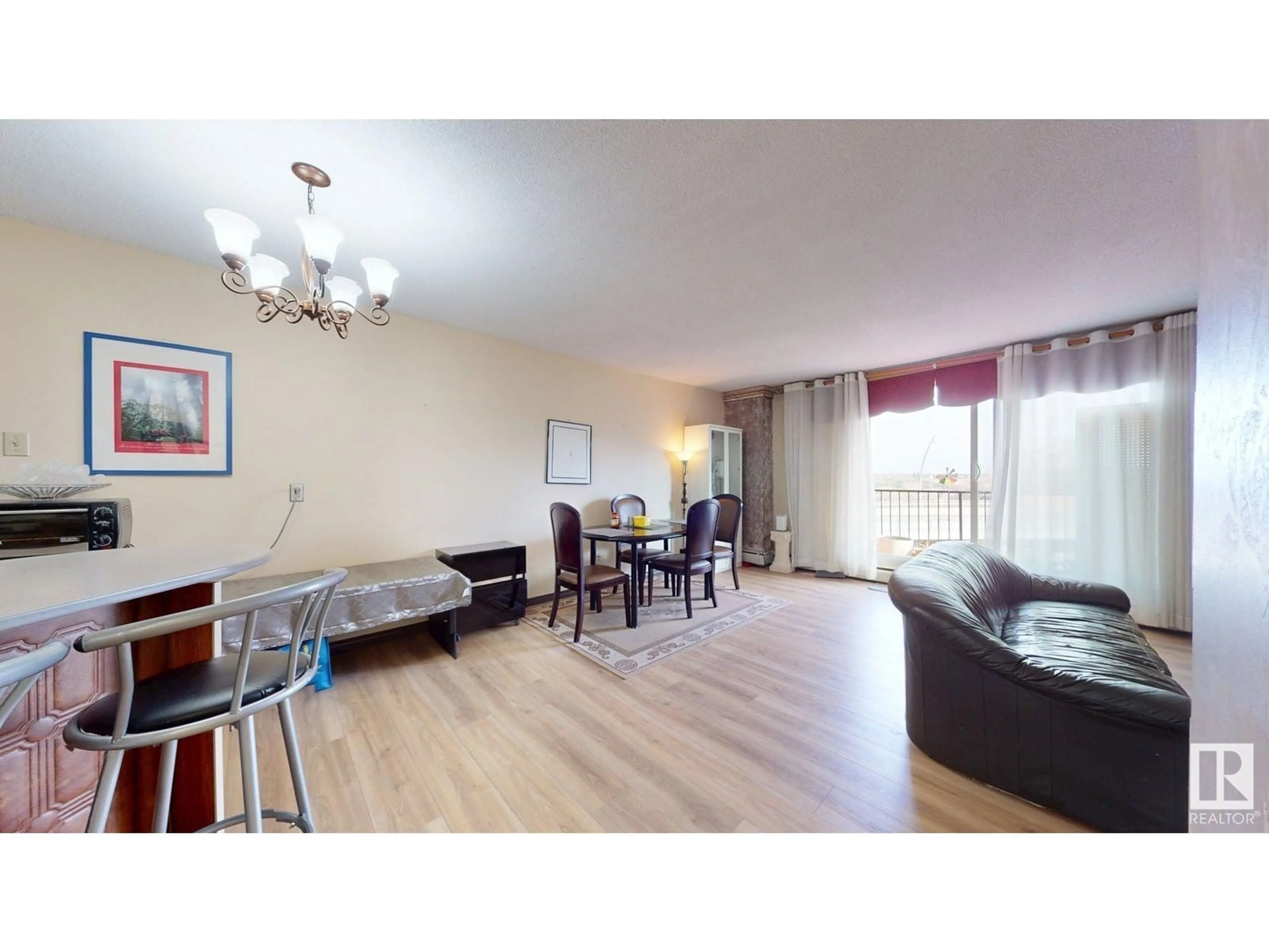 Living room with furniture, wood/laminate floor for #203 - 9028 JASPER AV NW, Edmonton Alberta T5H3S8
