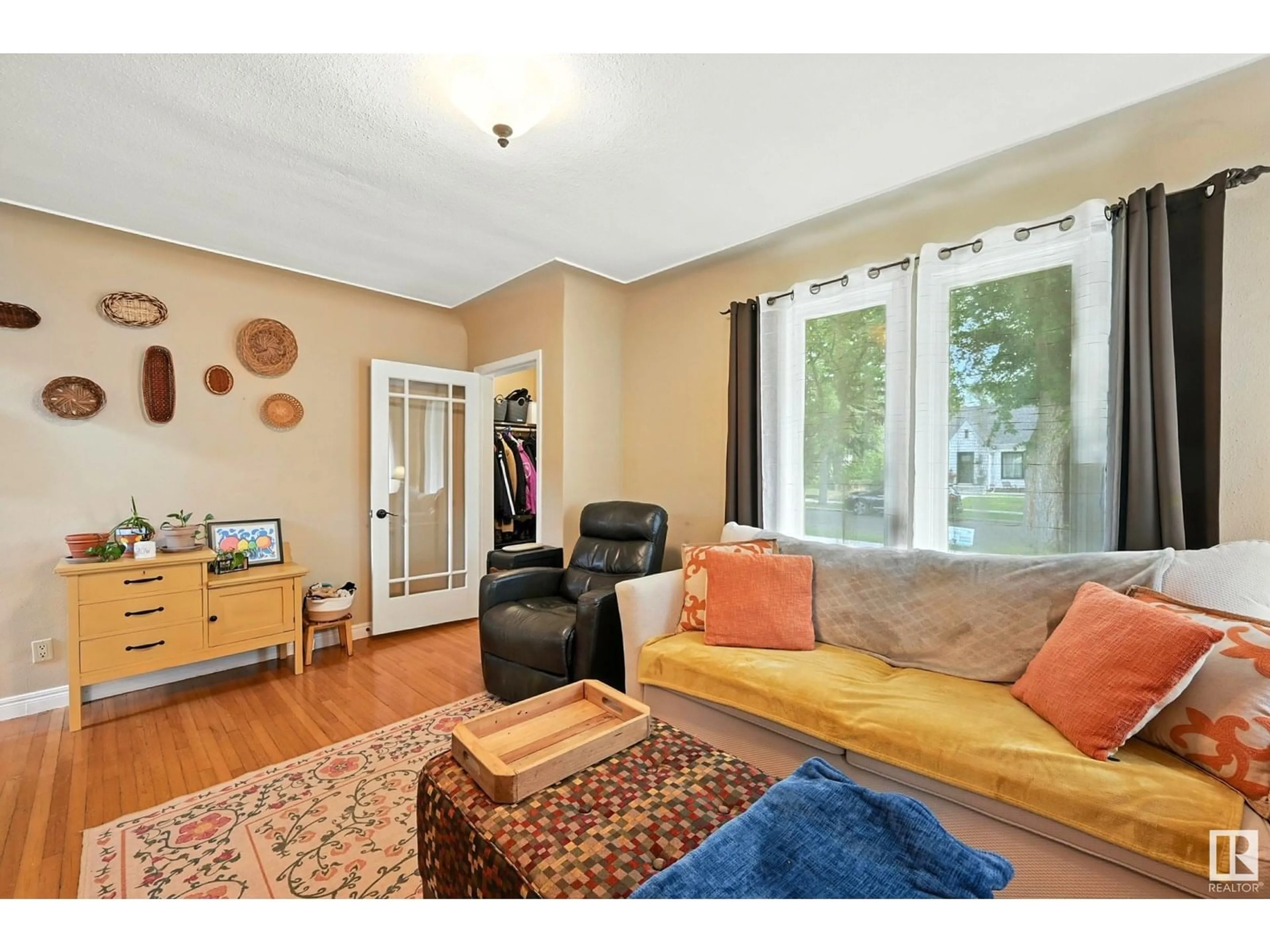 Living room with furniture, wood/laminate floor for 11322 60 ST, Edmonton Alberta T5W3Z1