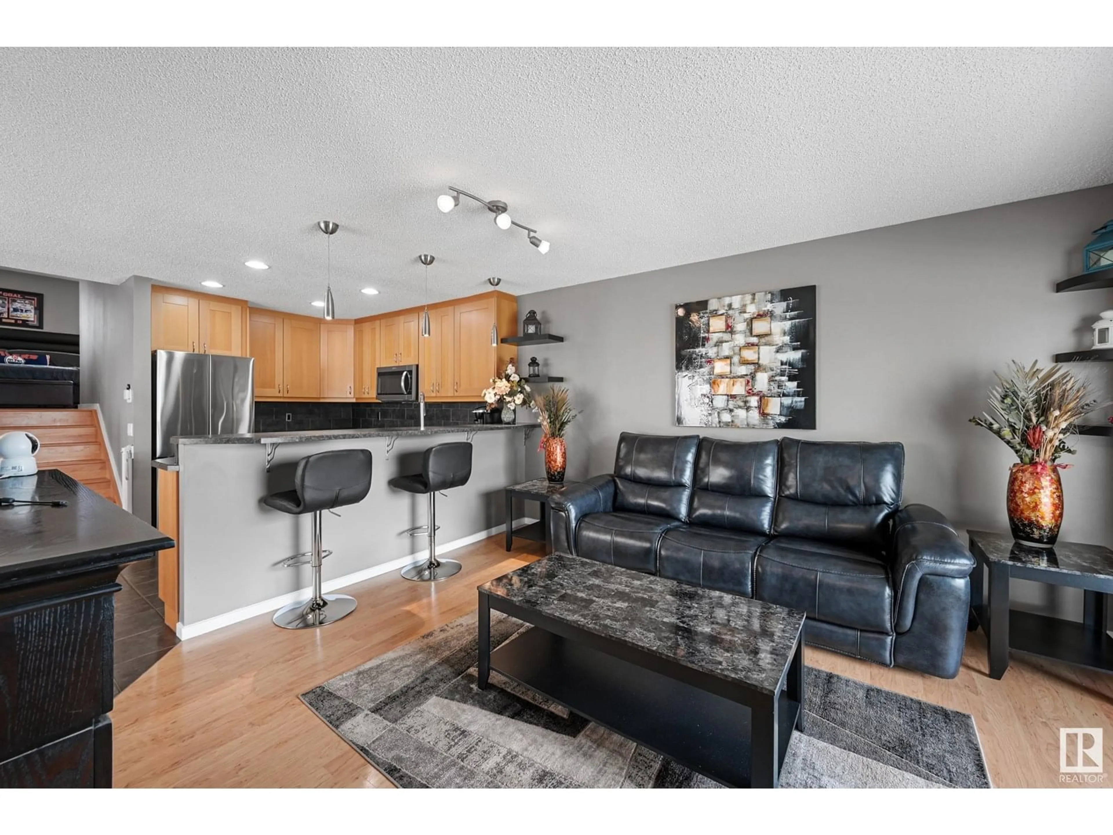 Living room with furniture, wood/laminate floor for 193 HYNDMAN CR, Edmonton Alberta T5A4X6