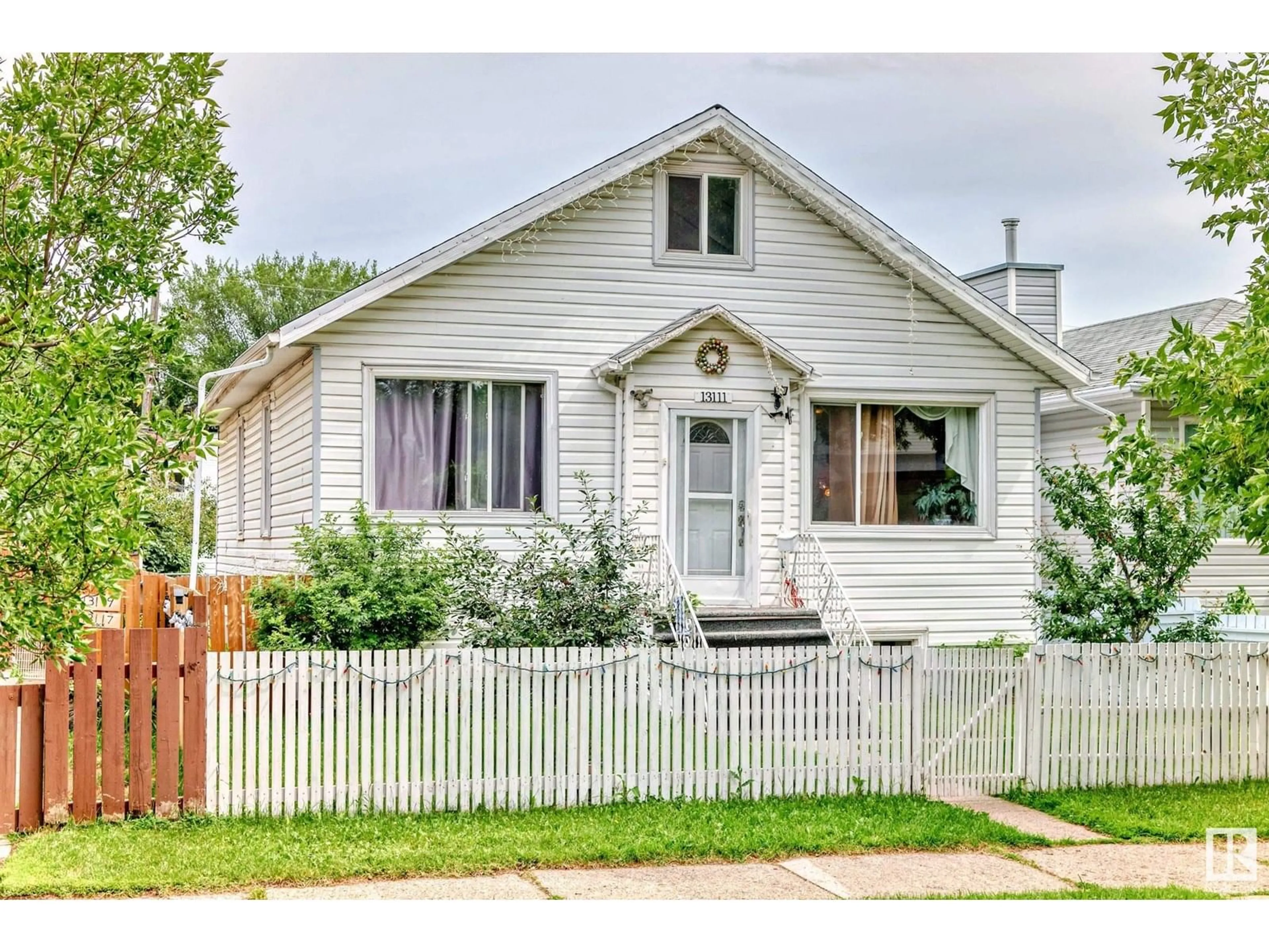 Home with vinyl exterior material, street for NW - 13111 65 ST, Edmonton Alberta T5A1A2