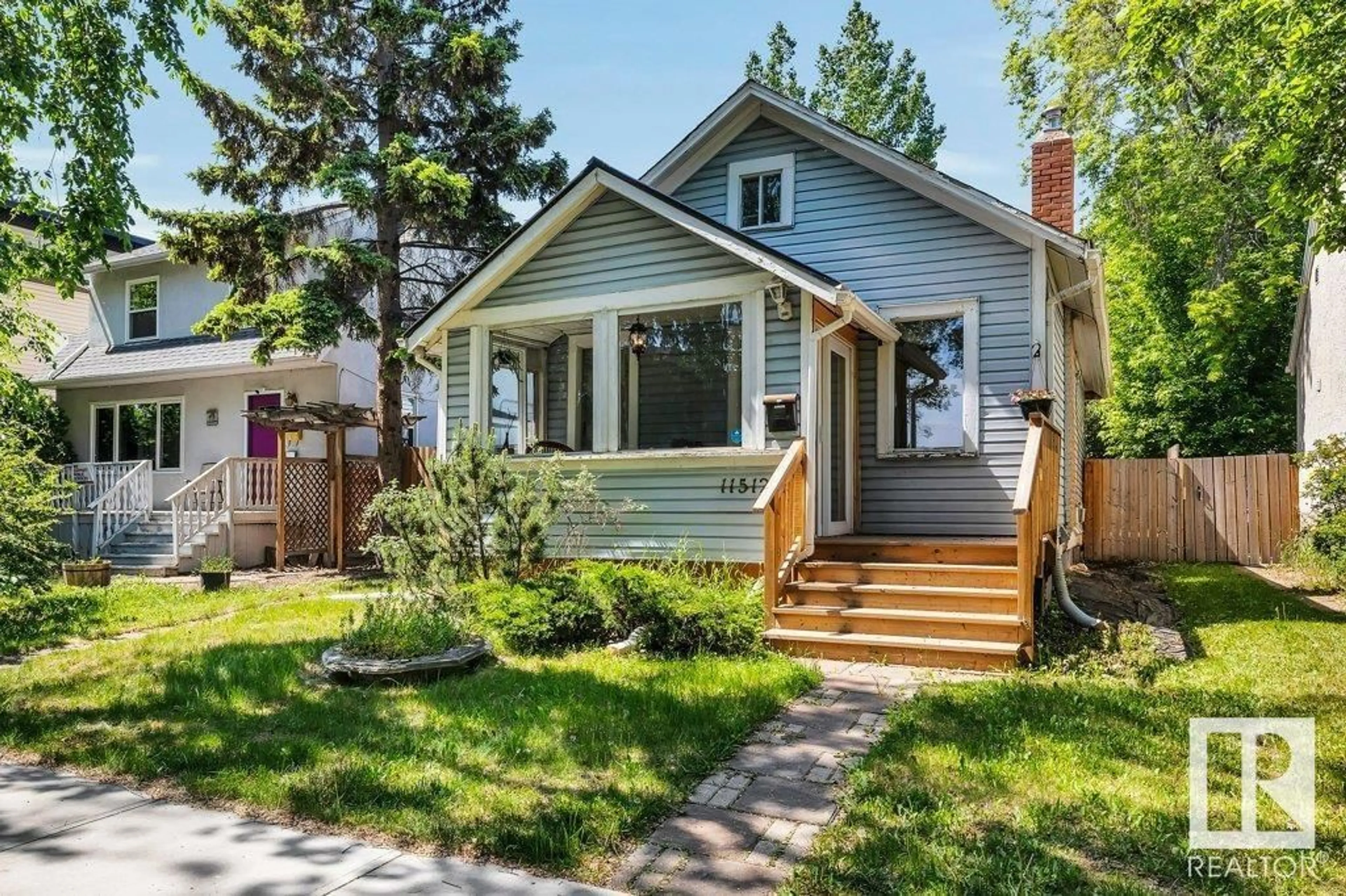 Home with vinyl exterior material, street for NW - 11512 122 ST, Edmonton Alberta T5M0C1