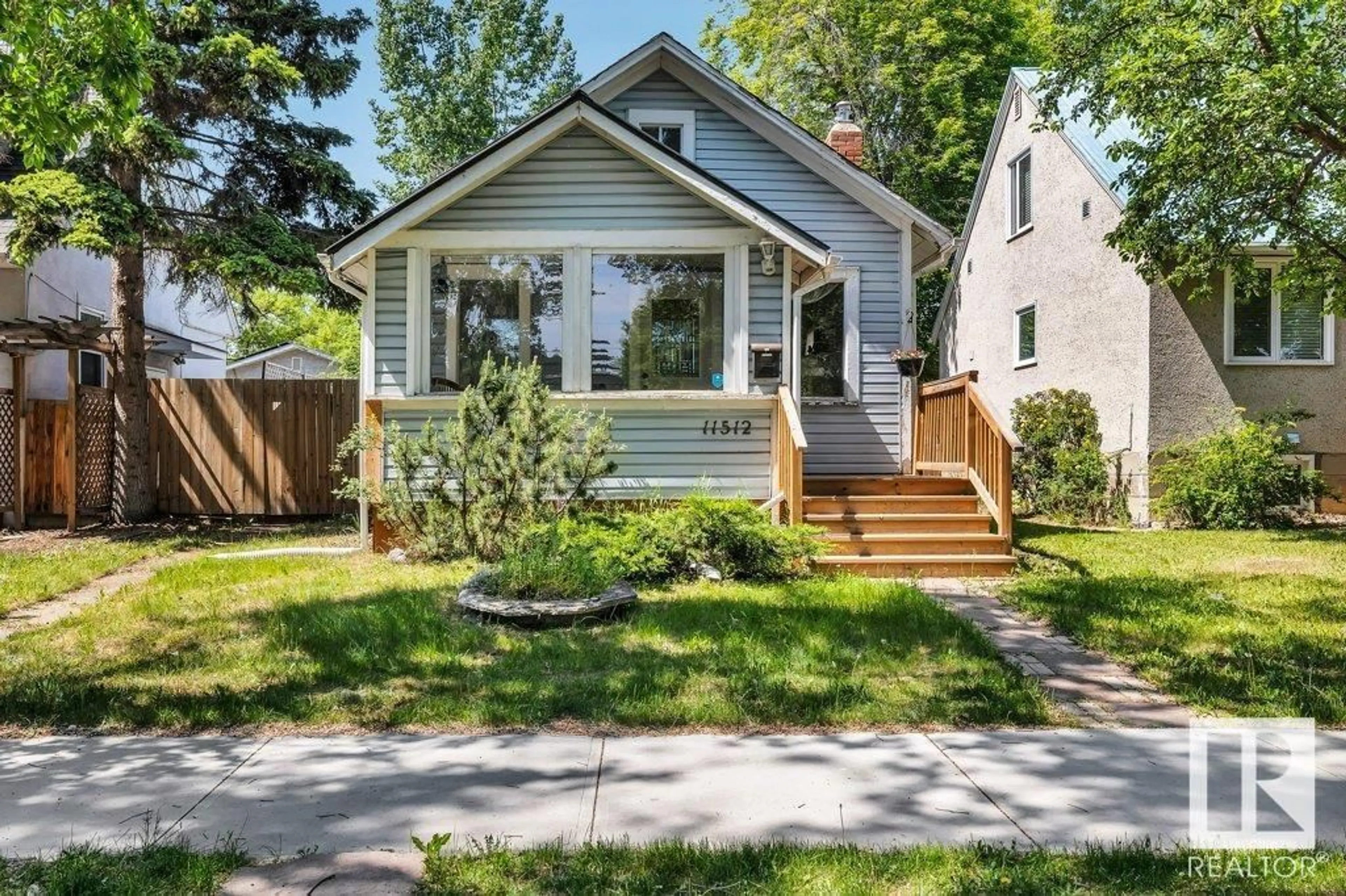 Home with vinyl exterior material, street for NW - 11512 122 ST, Edmonton Alberta T5M0C1