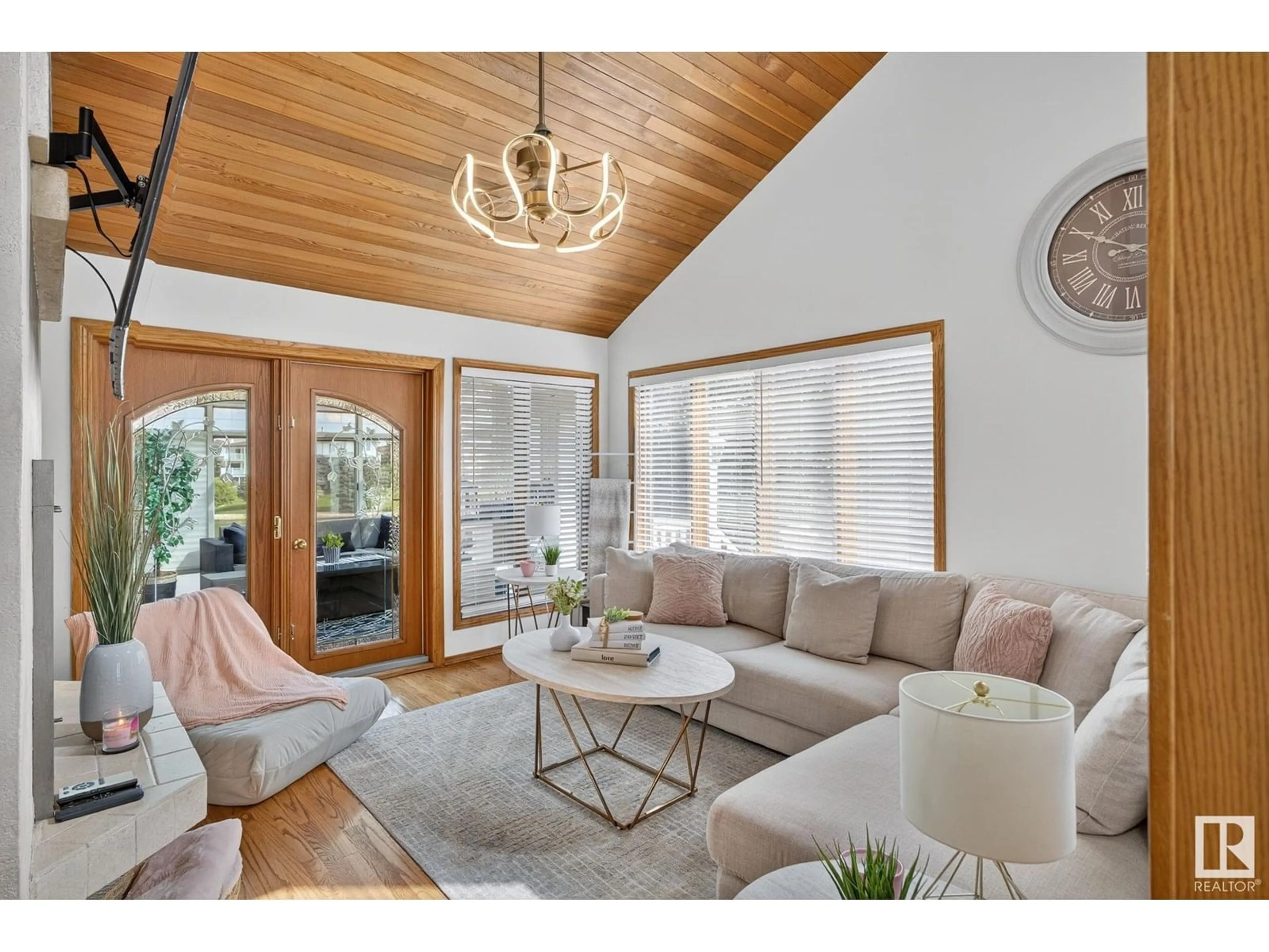 Living room with furniture, wood/laminate floor for 7604 157 AV NW, Edmonton Alberta T5Z2S2