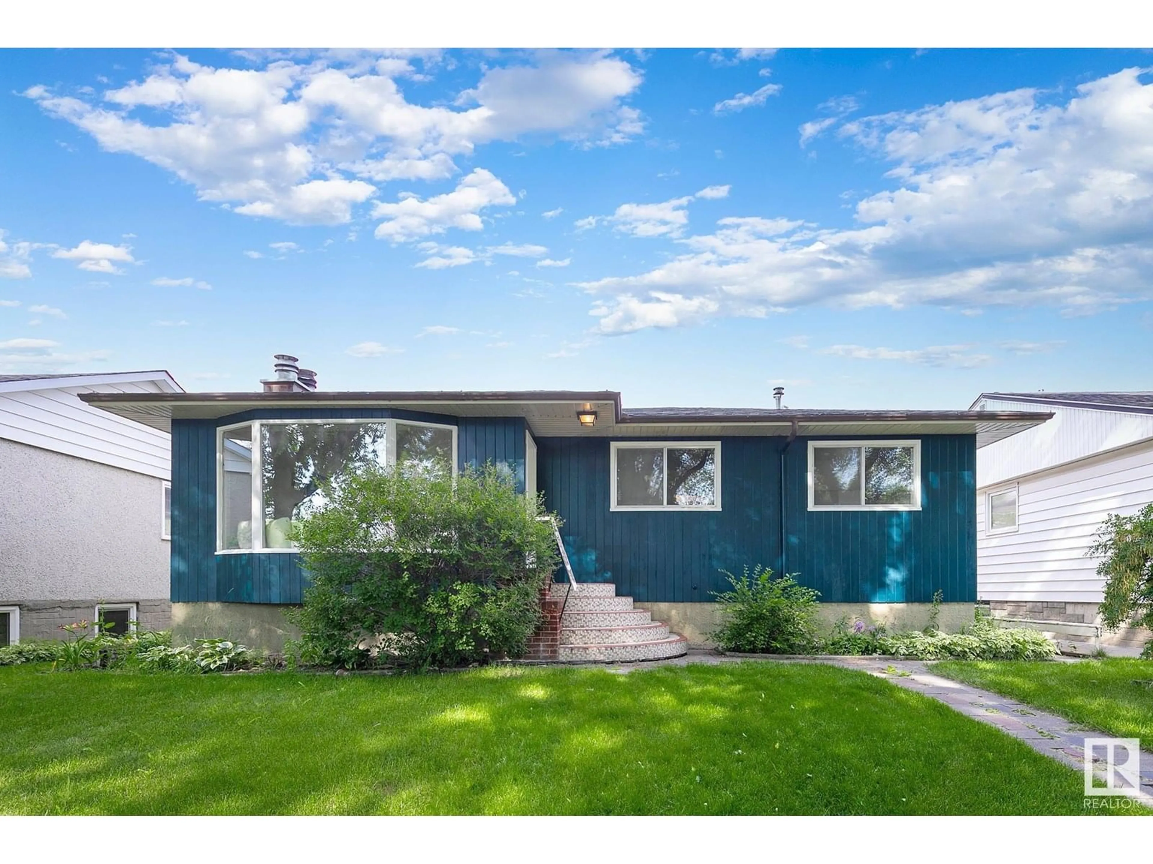 Home with vinyl exterior material, street for 12216 56 ST, Edmonton Alberta T5W3T4