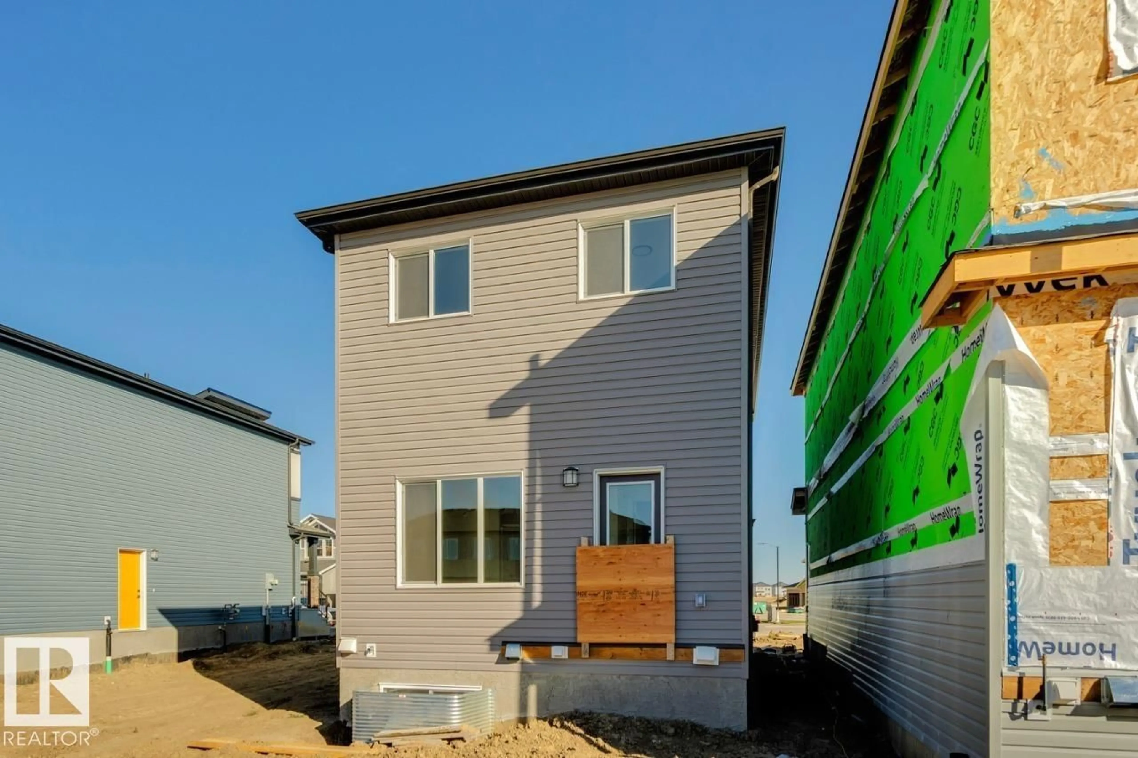 Home with vinyl exterior material, street for 203 WATTLE RD, Leduc Alberta T9E1L3