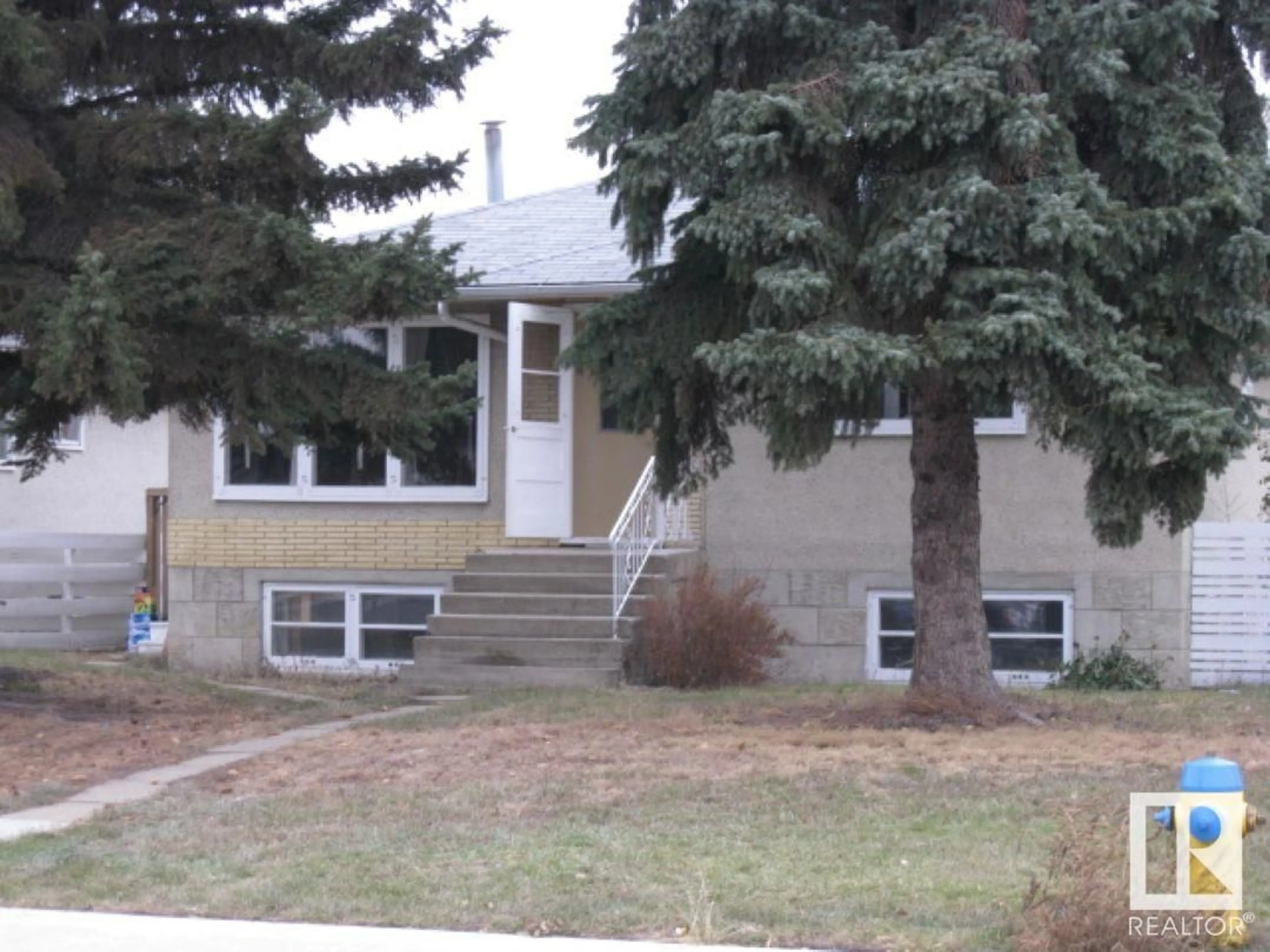 Home with vinyl exterior material, street for 12720 135 AV, Edmonton Alberta T5L3X5