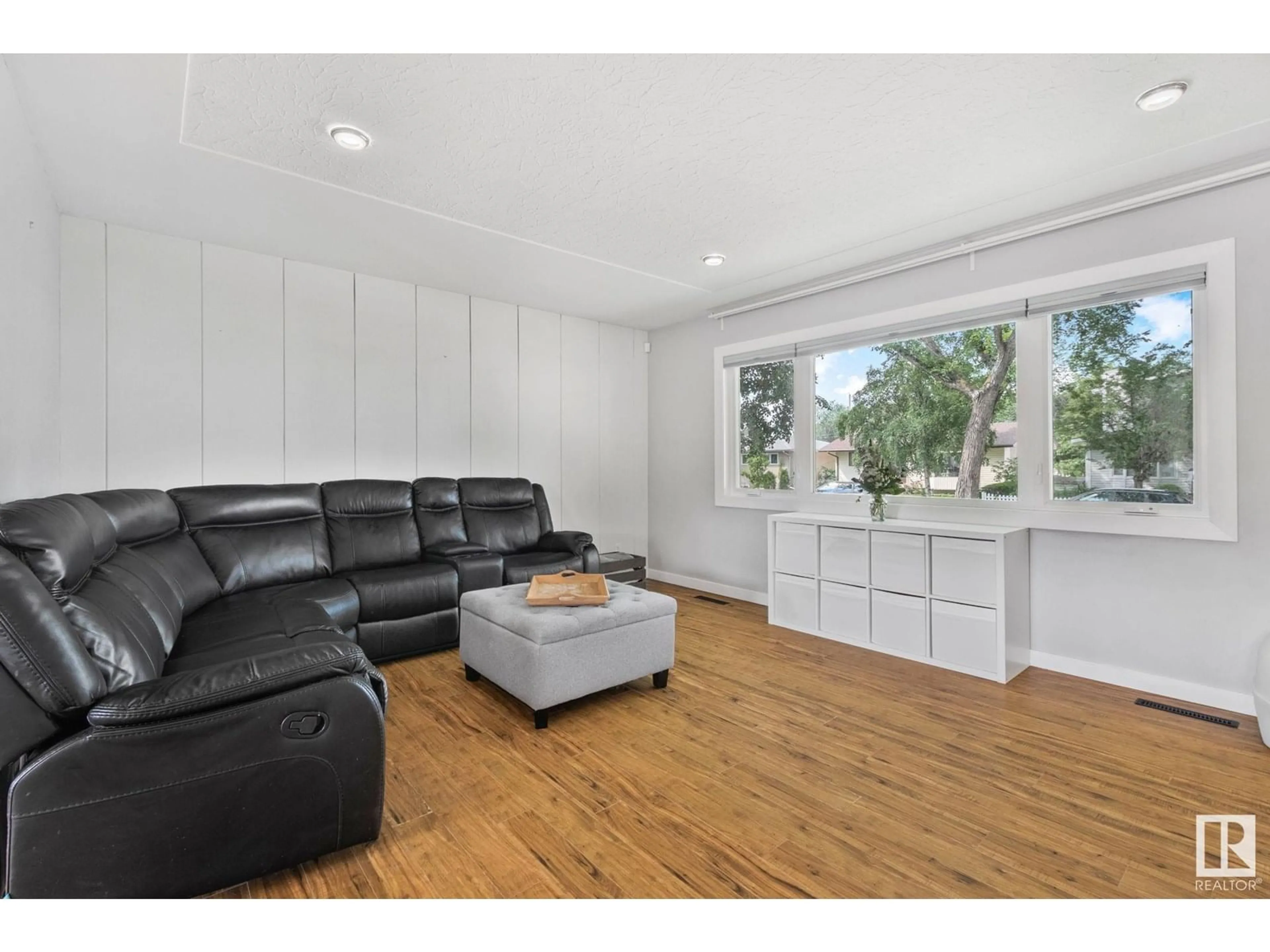 Living room with furniture, wood/laminate floor for 3613 113 AV, Edmonton Alberta T5W0P7