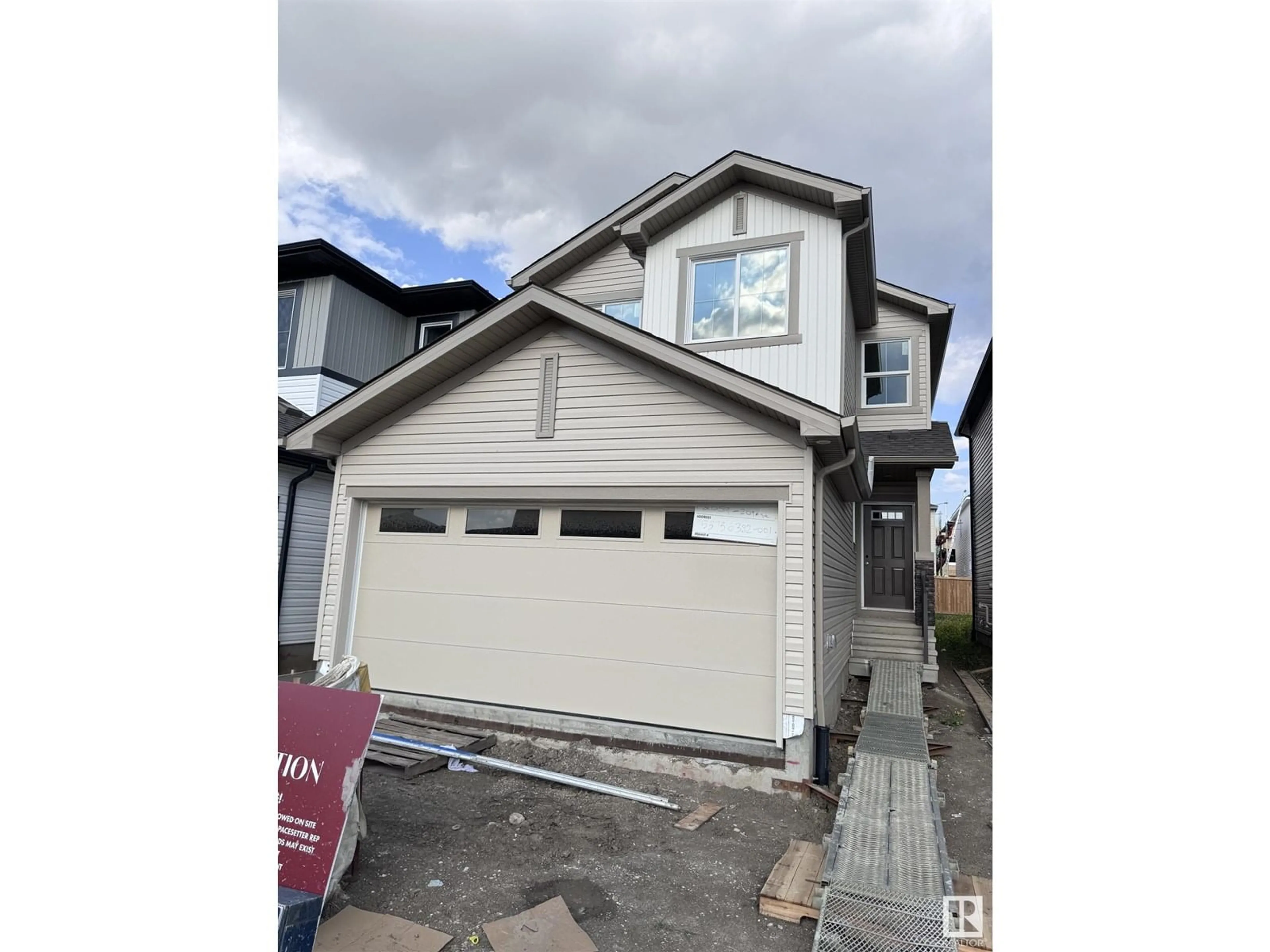 Home with vinyl exterior material, street for NW - 2009 209A ST, Edmonton Alberta T6M3C8