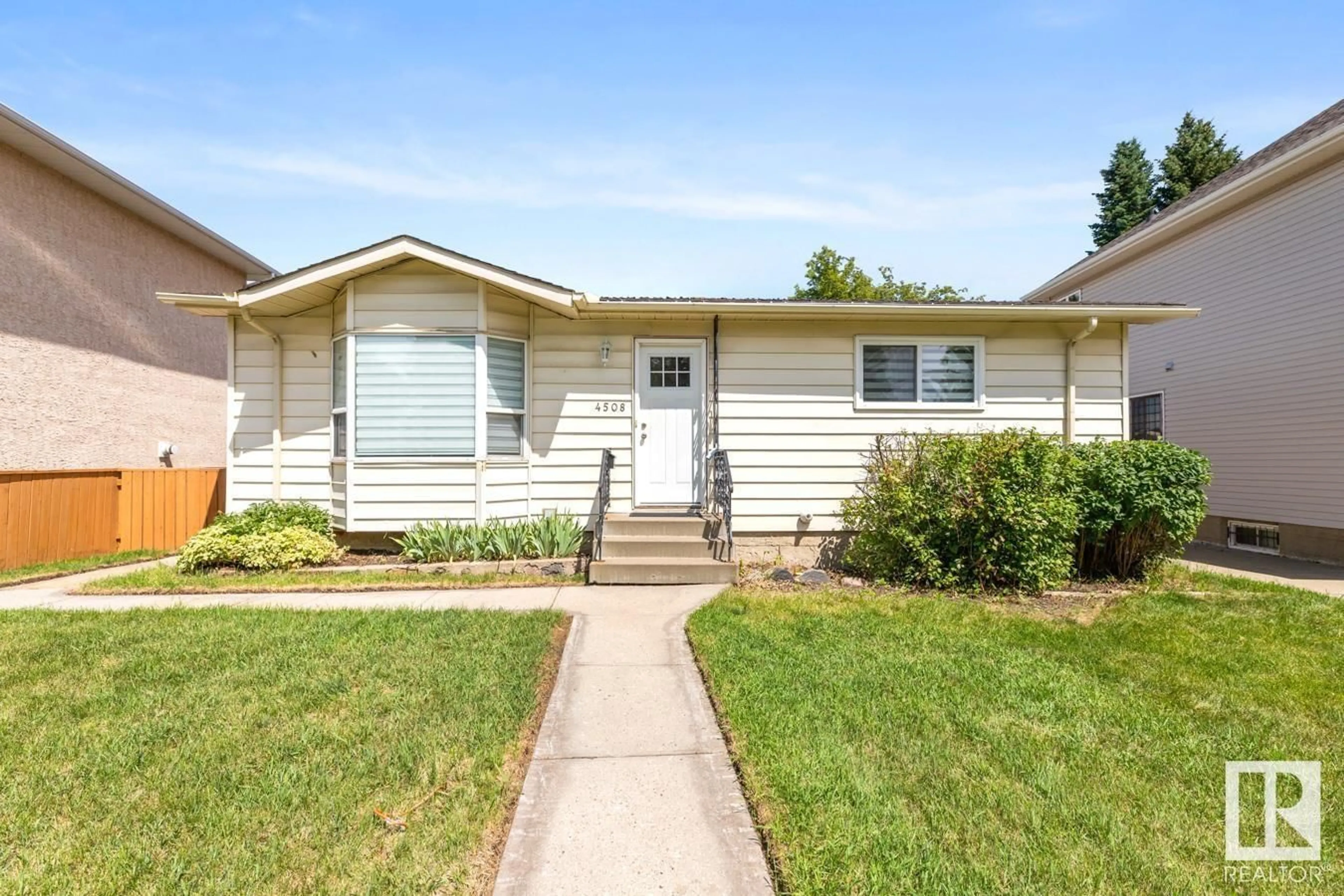 Home with vinyl exterior material, street for 4508 109A AV, Edmonton Alberta T6A1S4