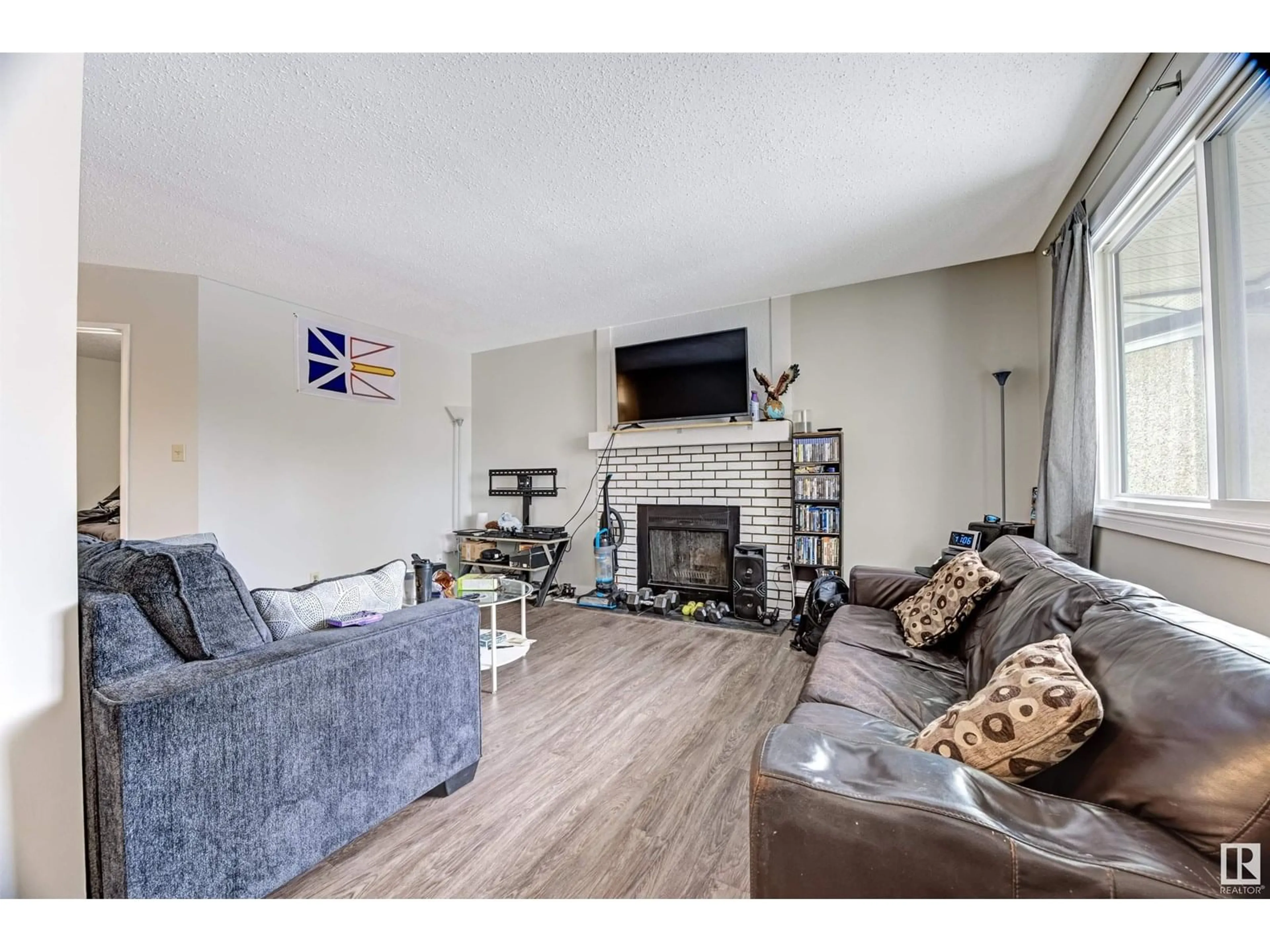 Living room with furniture, wood/laminate floor for #302 - 6204 180 ST, Edmonton Alberta T5T3J9