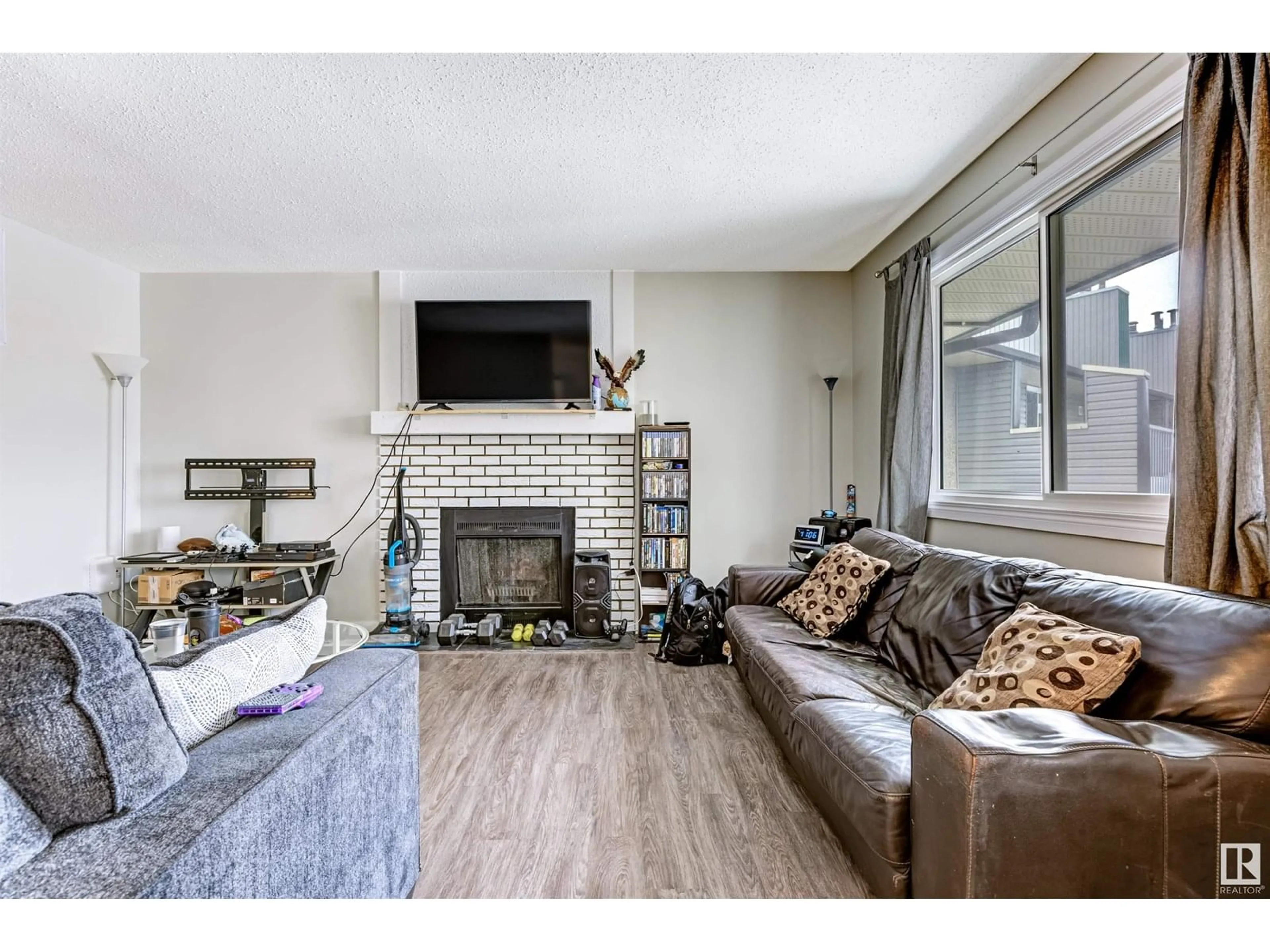 Living room with furniture, wood/laminate floor for #302 - 6204 180 ST, Edmonton Alberta T5T3J9