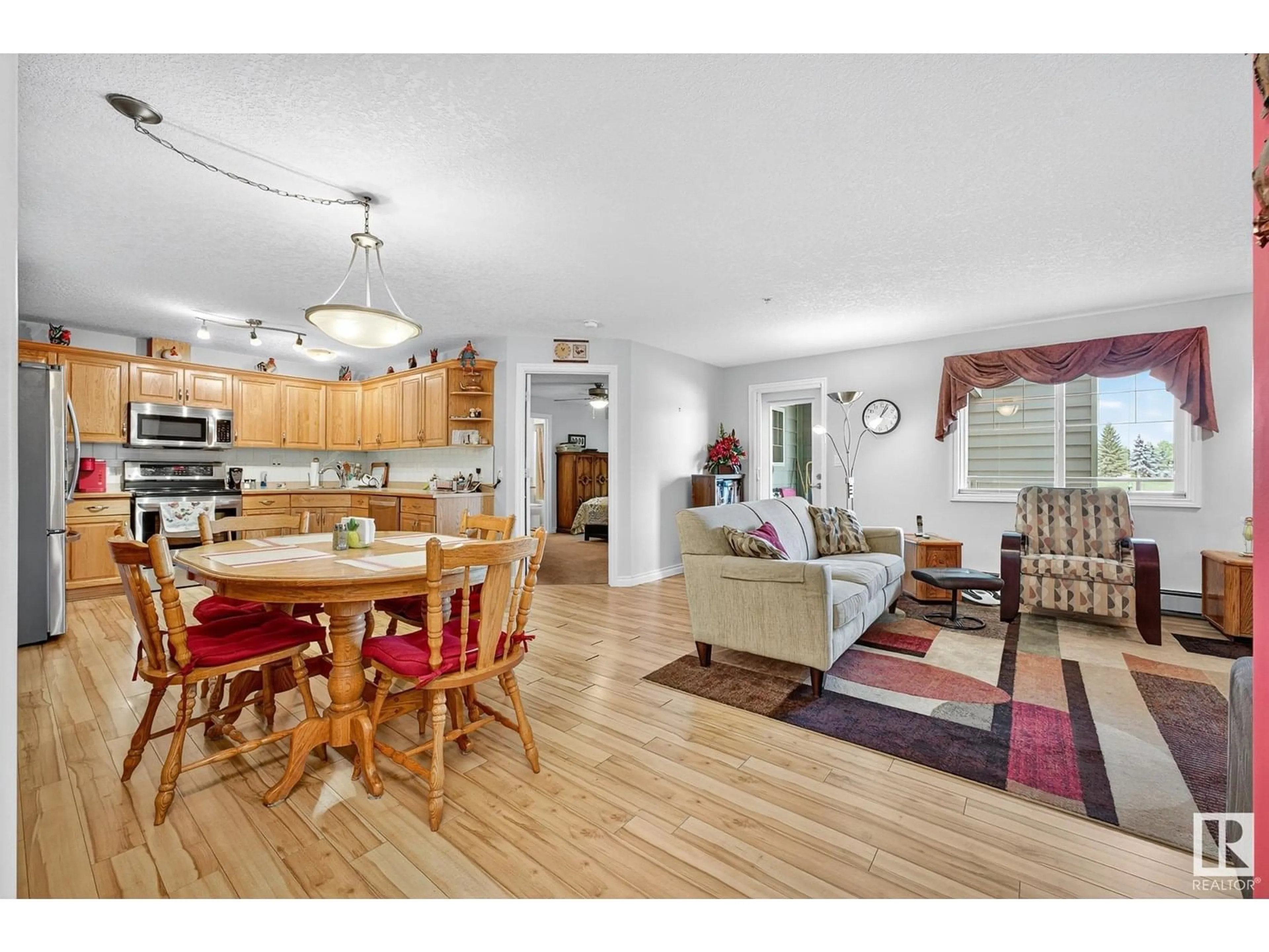 Open concept kitchen, wood/laminate floor for 202 - 9995 93 AV, Fort Saskatchewan Alberta T8L1N5