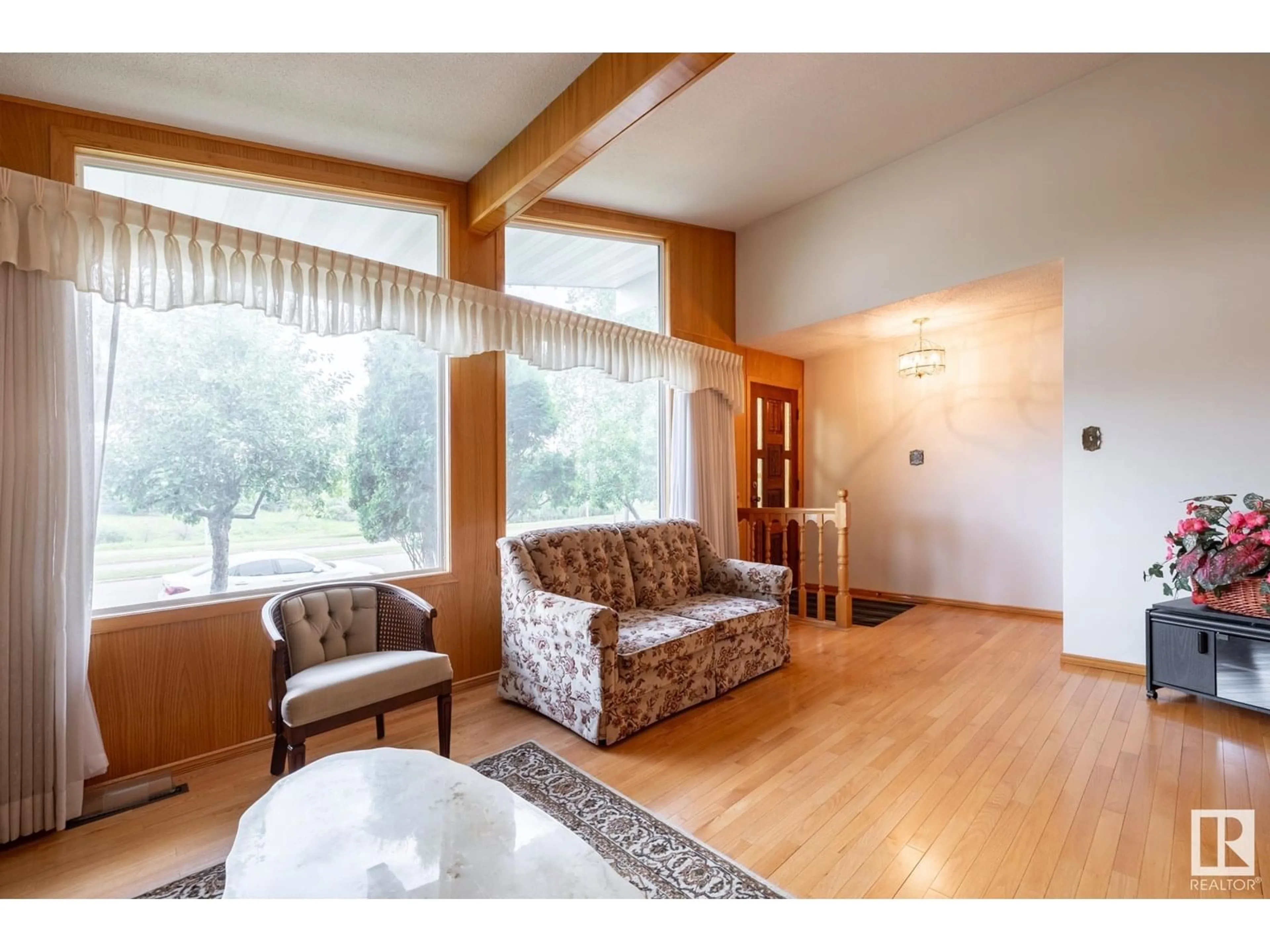 Living room with furniture, wood/laminate floor for 11531 51 AV, Edmonton Alberta T6H0M3