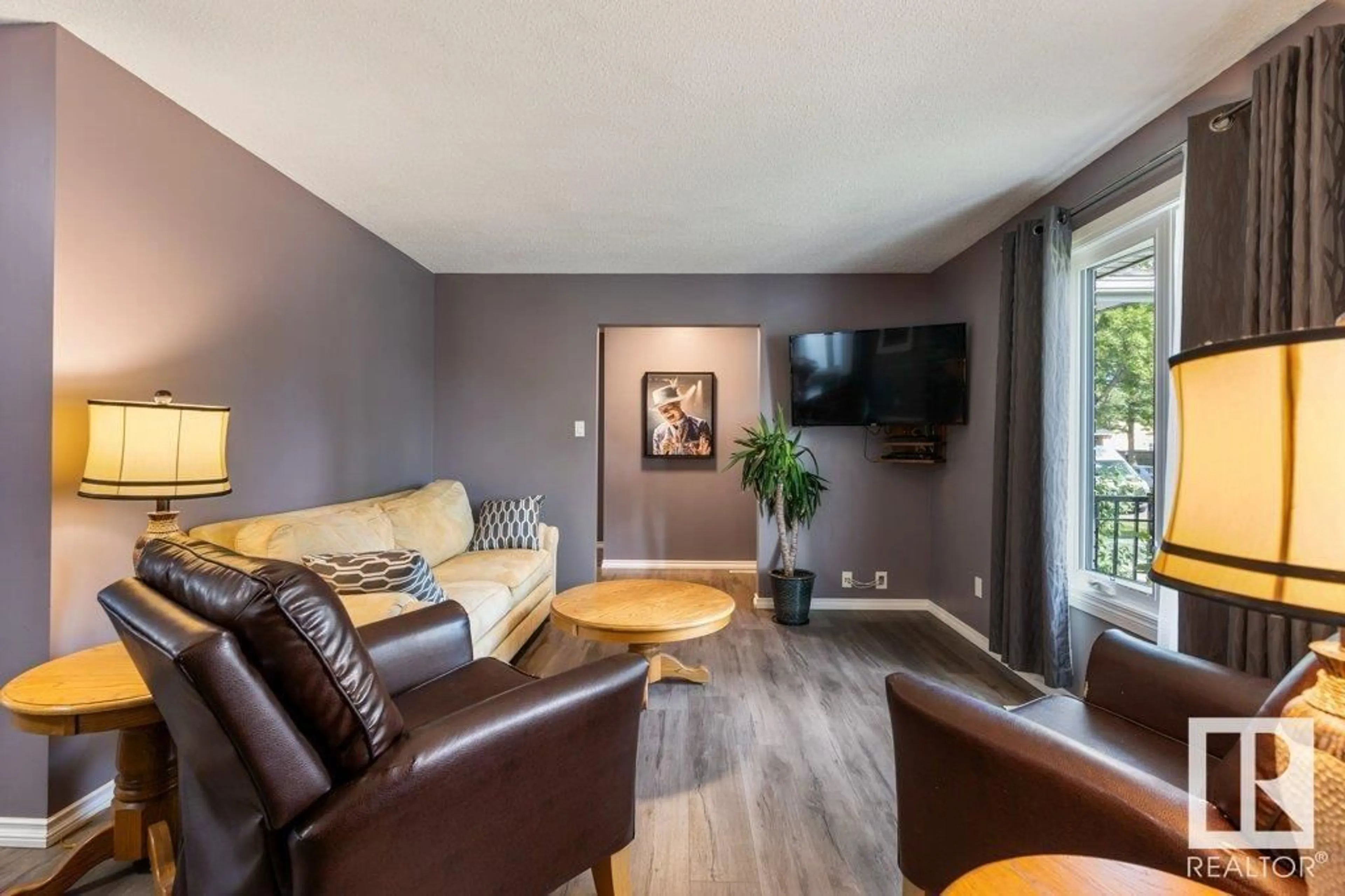 Living room with furniture, wood/laminate floor for 10324 164 AV, Edmonton Alberta T5X2E2