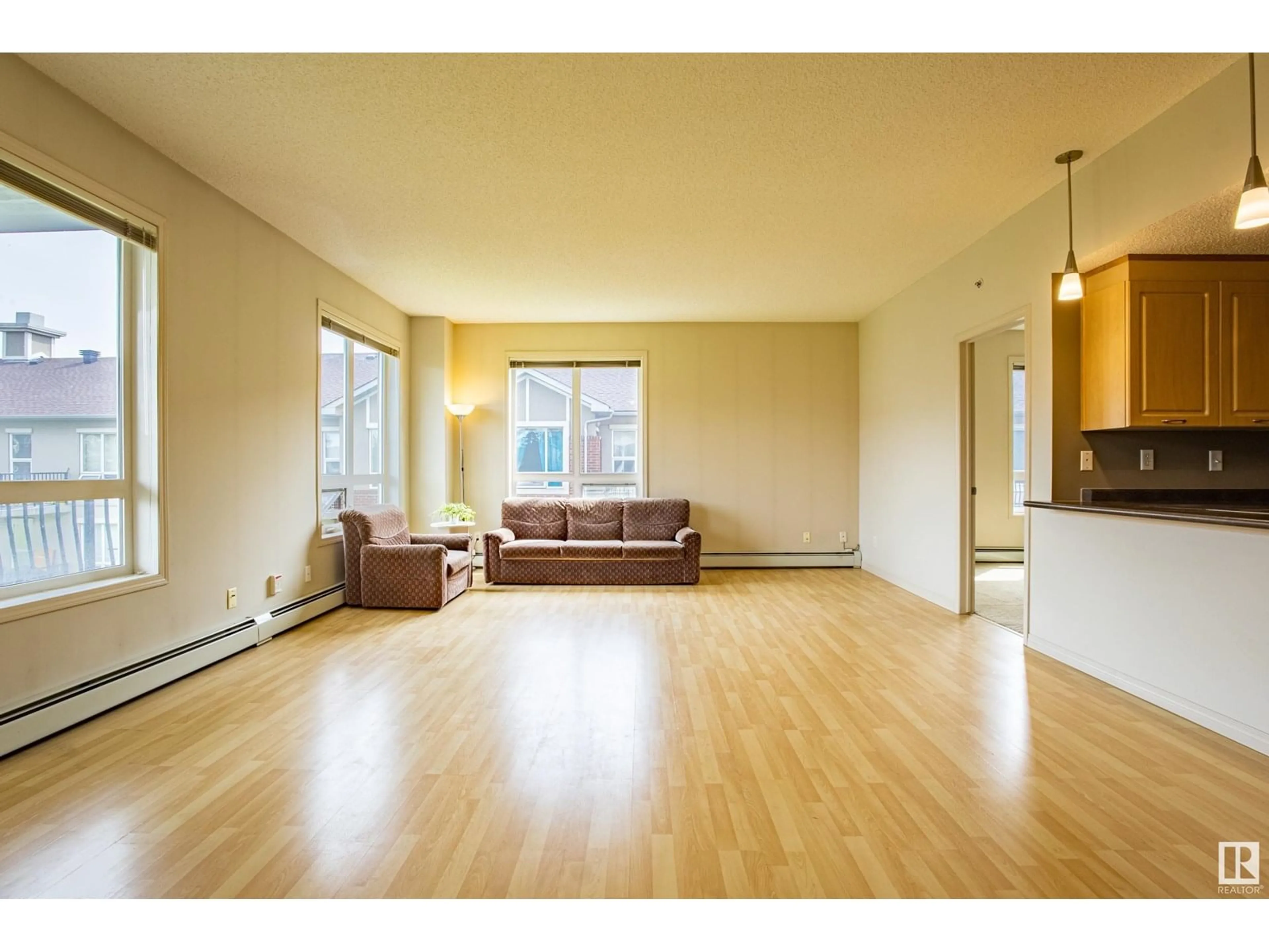 Living room with furniture, wood/laminate floor for #319 - 6315 135 AV, Edmonton Alberta T5A5J7