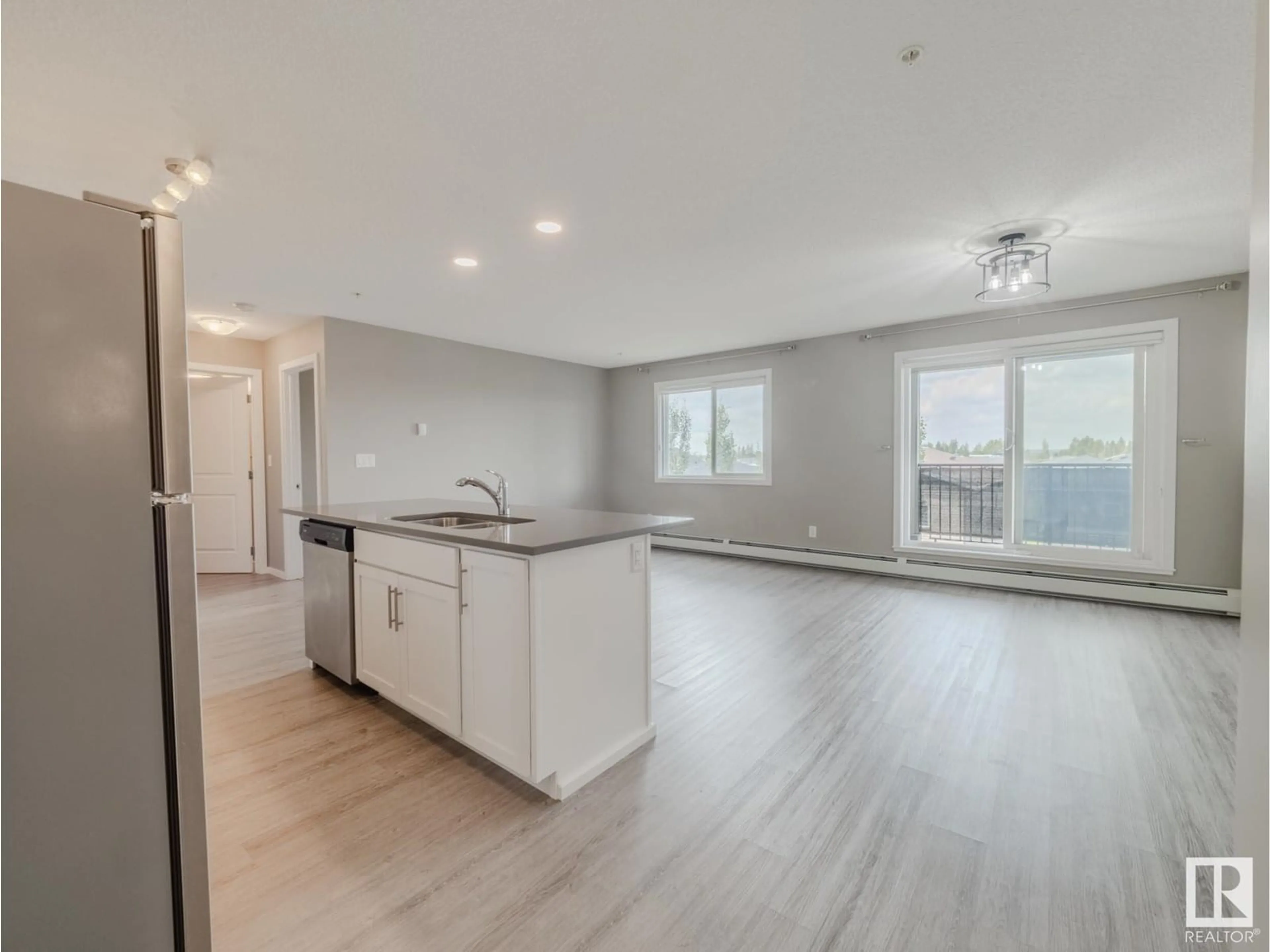 Open concept kitchen, wood/laminate floor for #310 - 394 WINDERMERE RD, Edmonton Alberta T6W2P2