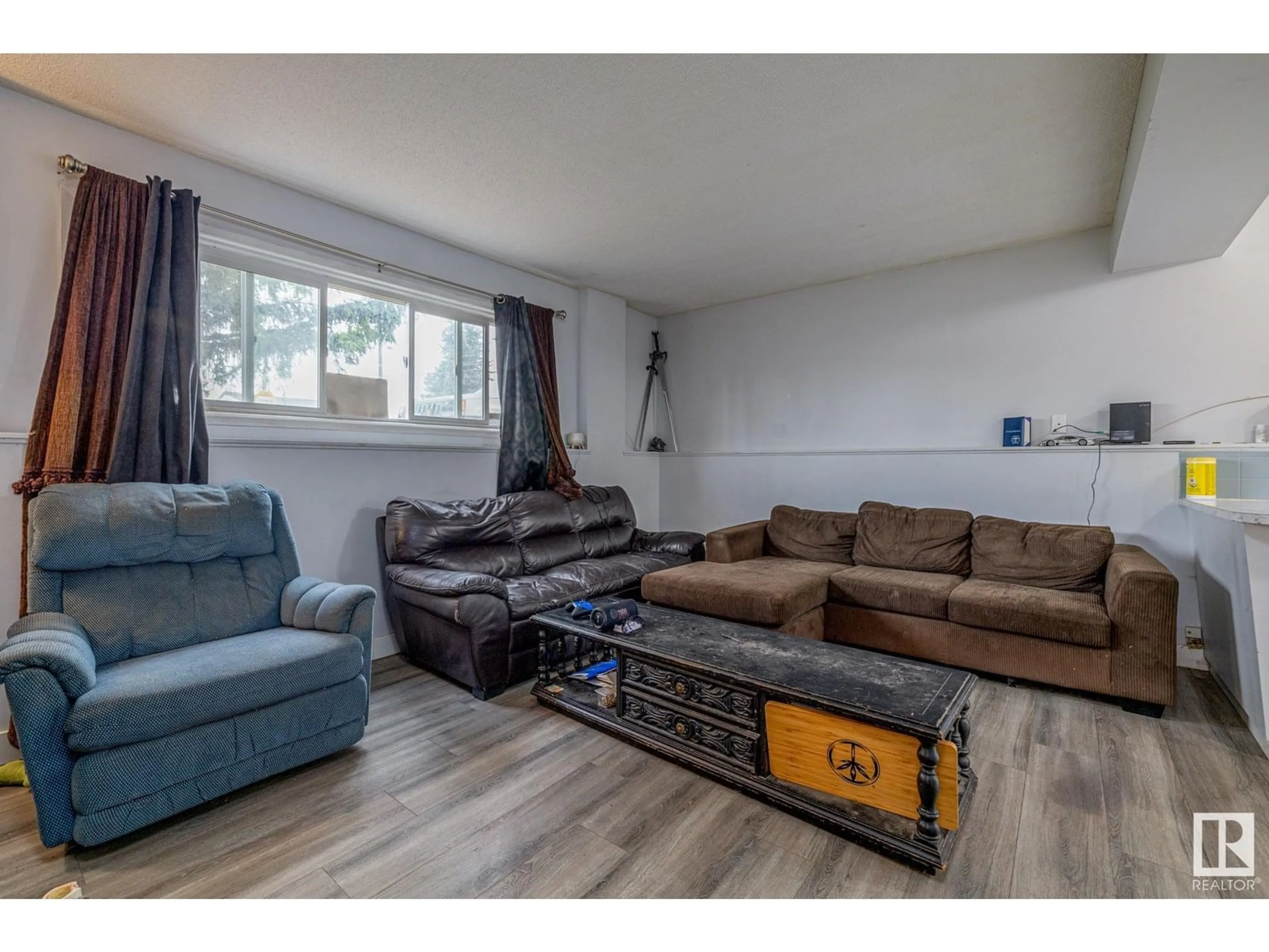 Living room with furniture, wood/laminate floor for 6120 132 AV, Edmonton Alberta T5A0J3