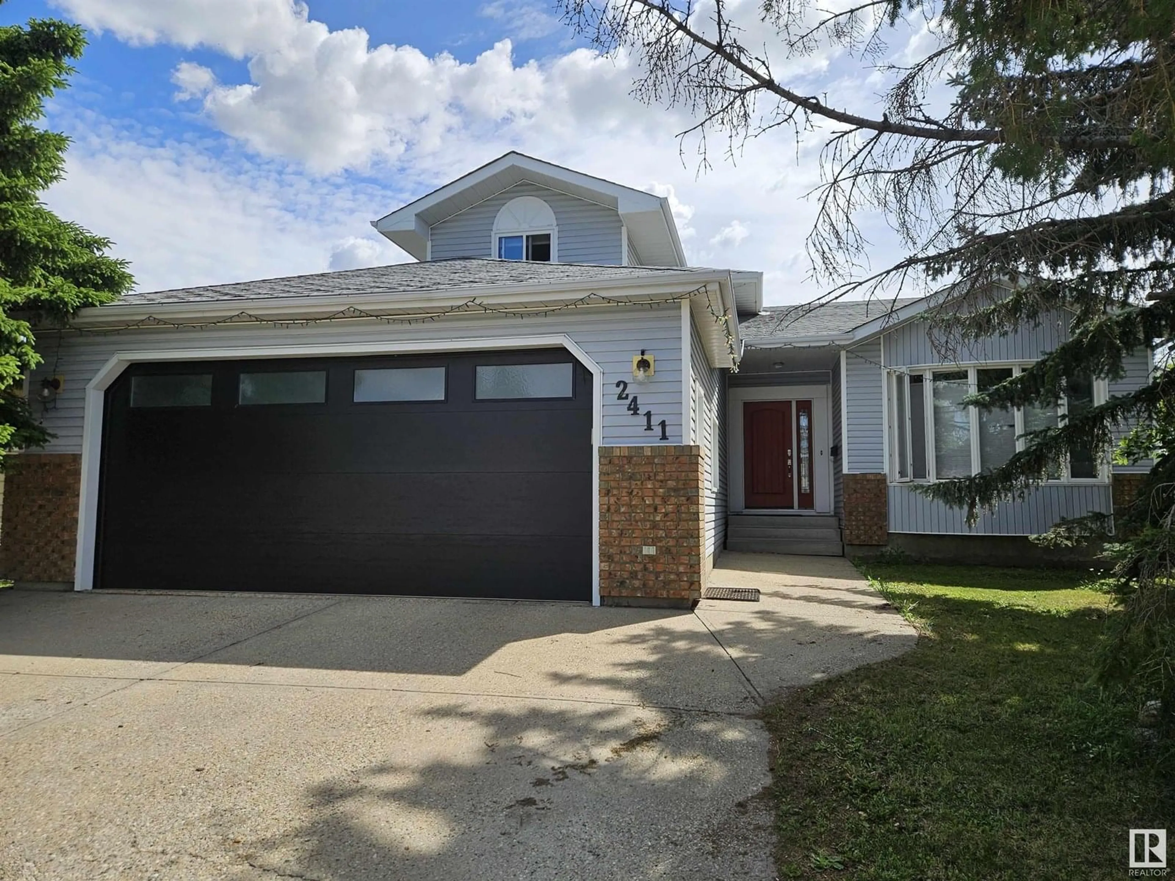 Home with vinyl exterior material, street for NW - 2411 78 ST, Edmonton Alberta T6K3W3