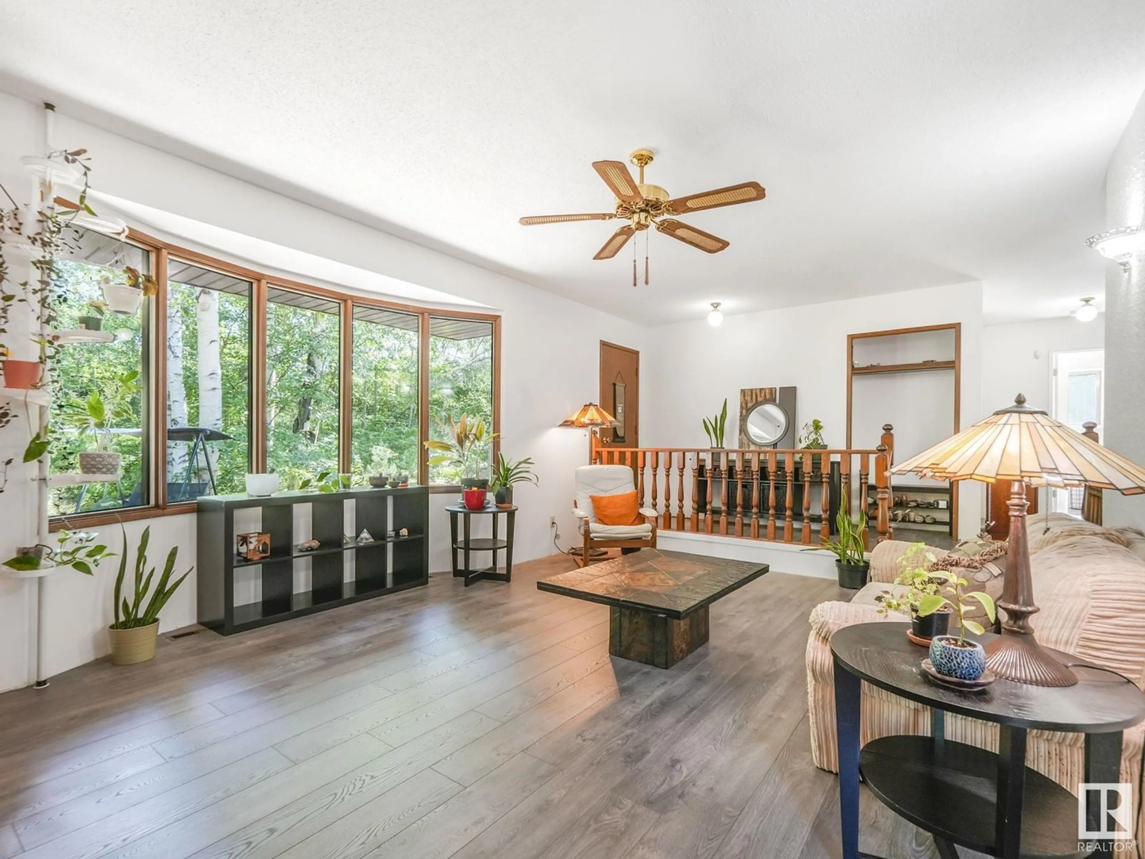 Living room with furniture, wood/laminate floor for 33 52519 RGE ROAD 21, Rural Parkland County Alberta T7Y2H1