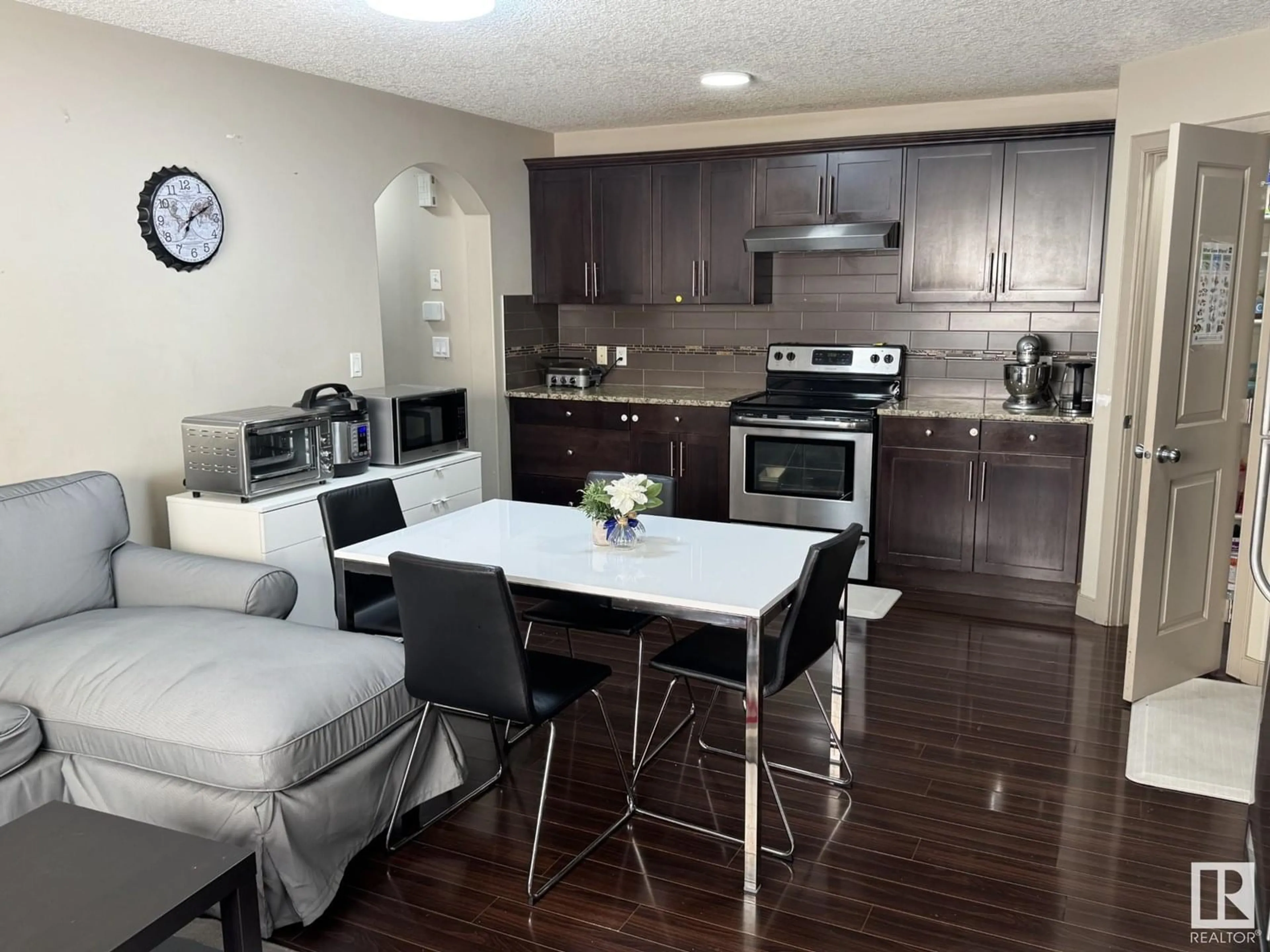 Open concept kitchen, wood/laminate floor for #15 - 1820 34 AV, Edmonton Alberta T6T9N9
