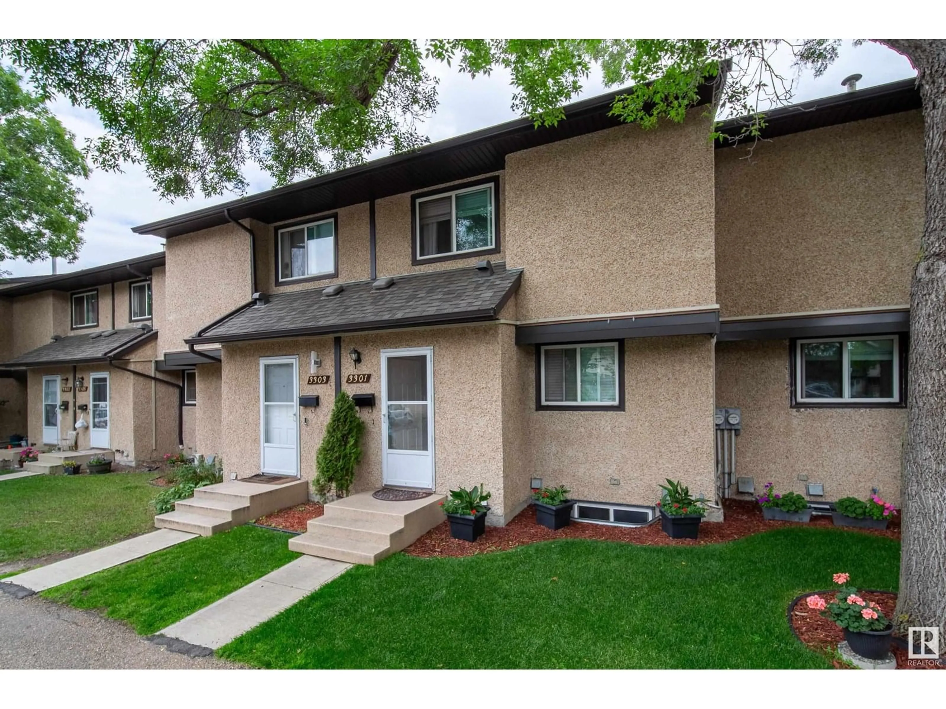 Home with vinyl exterior material, street for NW - 3301 142 AV, Edmonton Alberta T5Y1M9