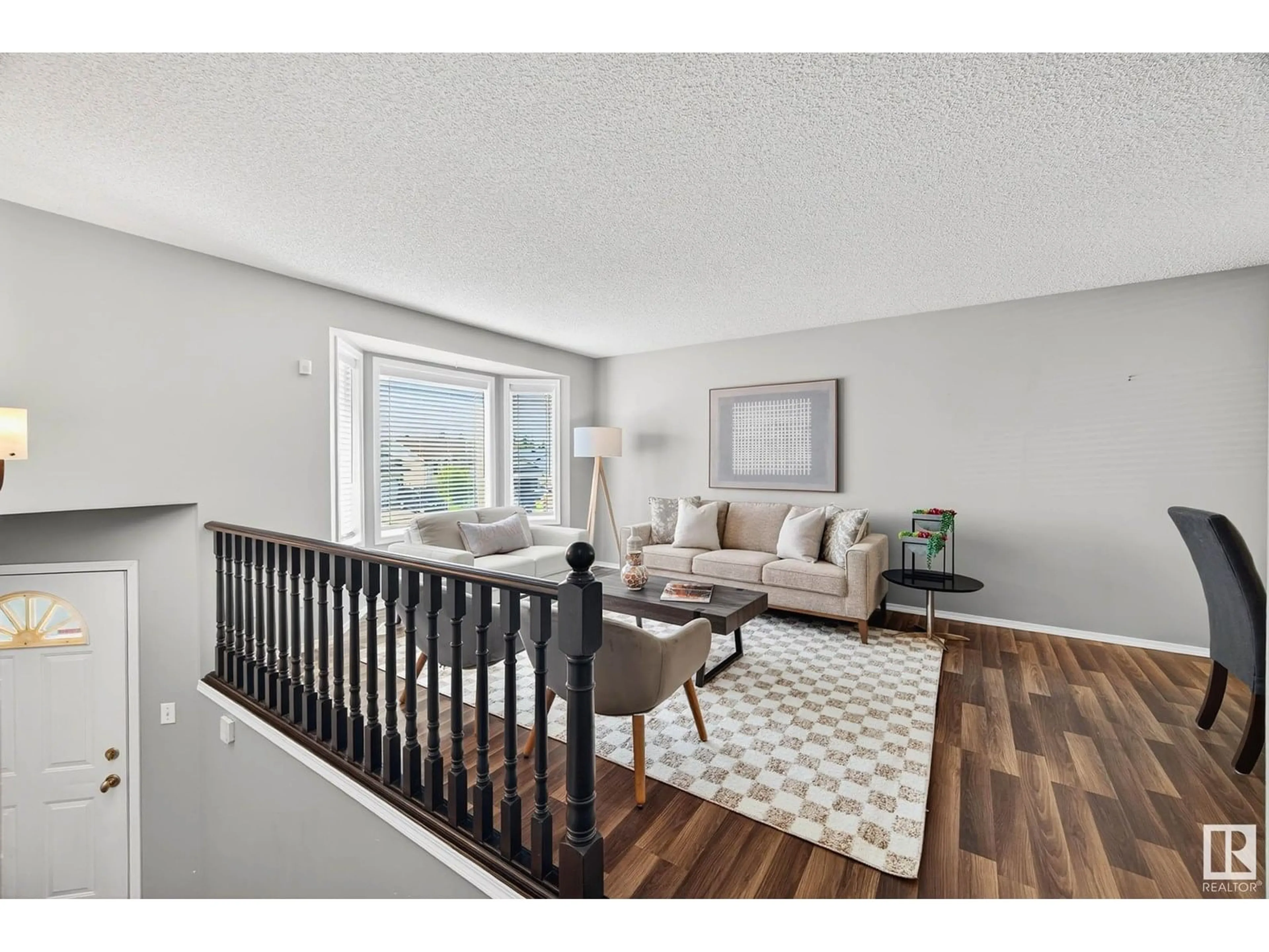 Living room with furniture, wood/laminate floor for 1079 JONES CR, Edmonton Alberta T6L6Y1