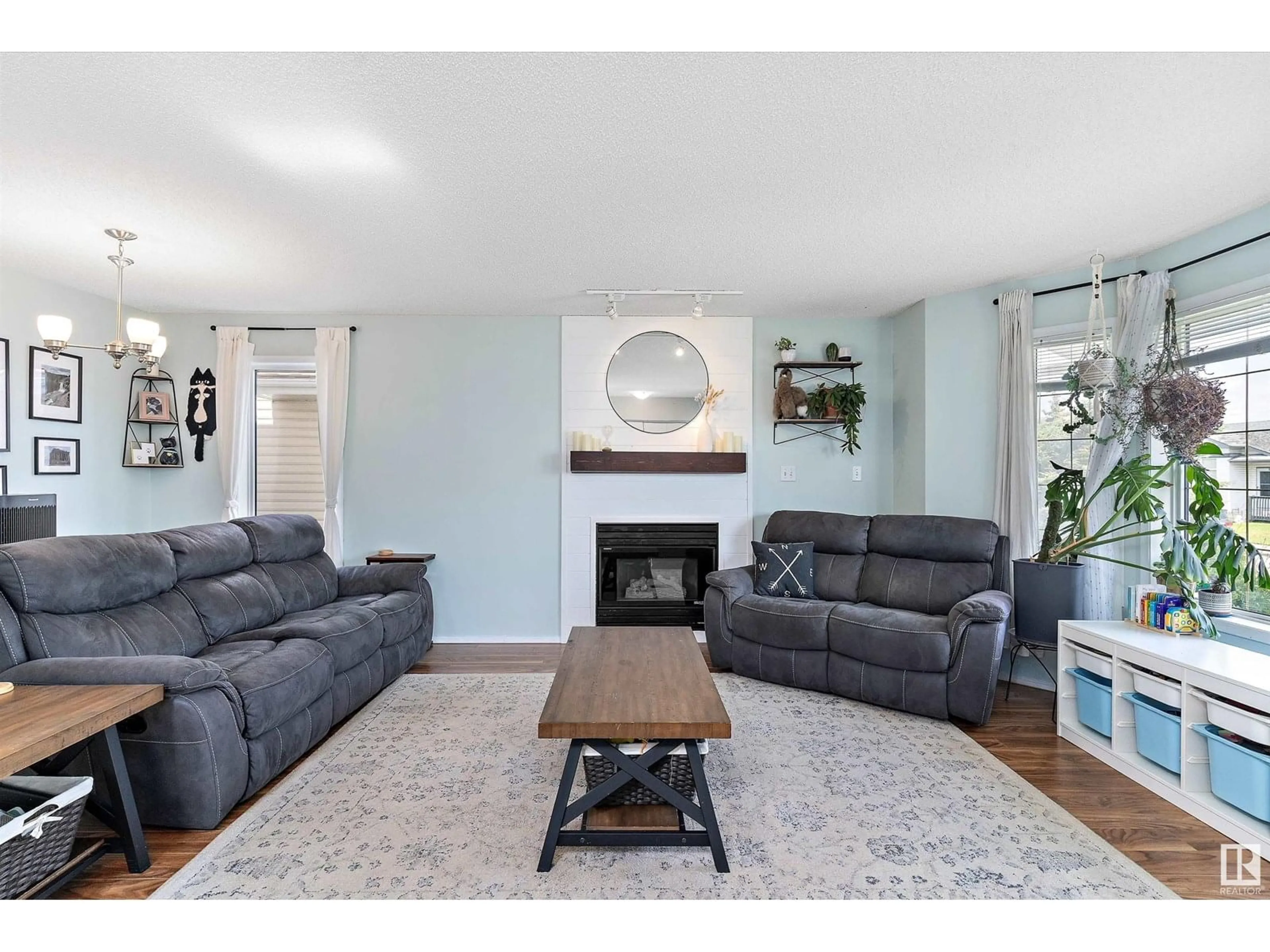 Living room with furniture, wood/laminate floor for 16218 56 ST, Edmonton Alberta T5Y2V1
