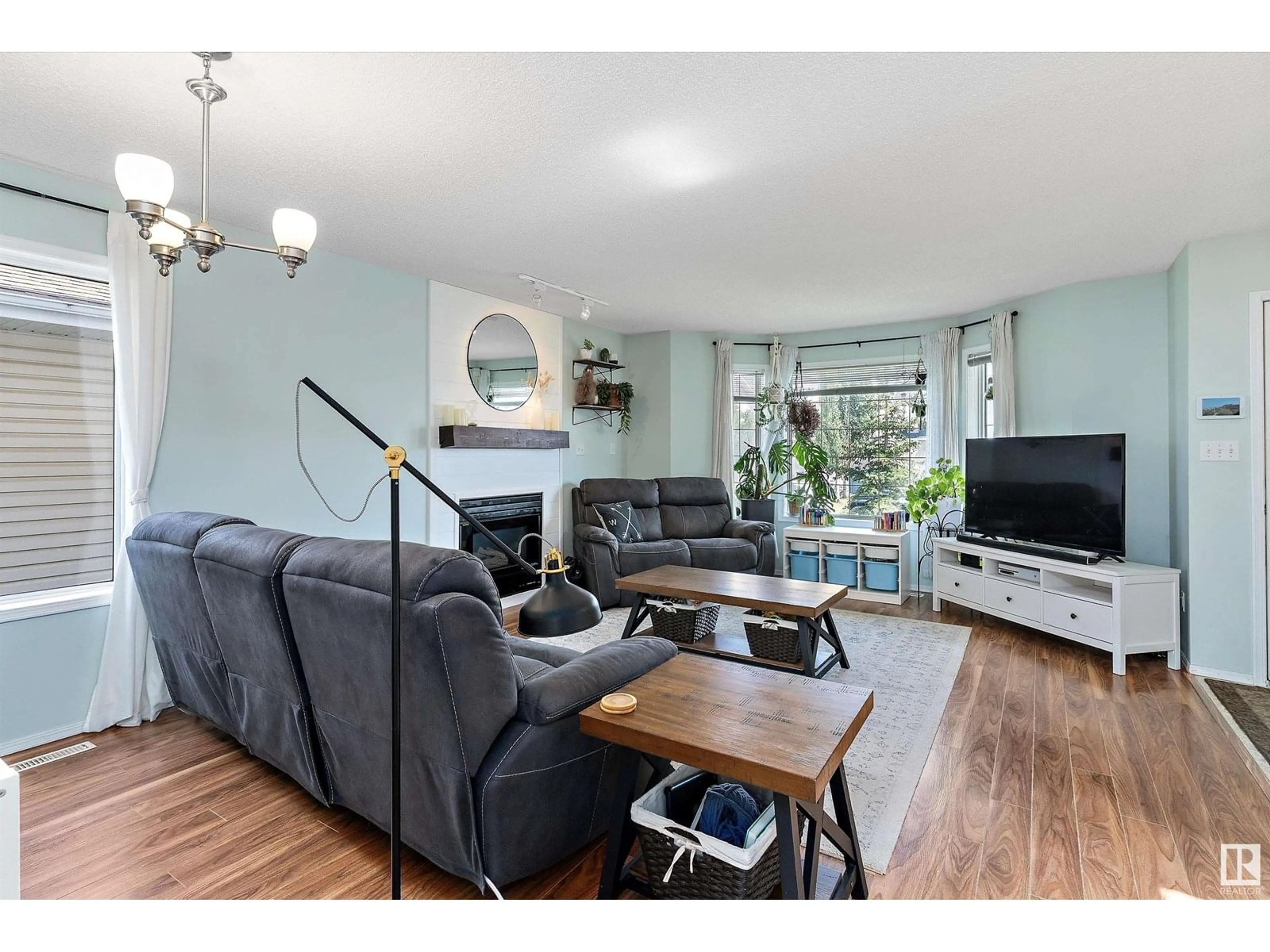 Living room with furniture, wood/laminate floor for 16218 56 ST, Edmonton Alberta T5Y2V1