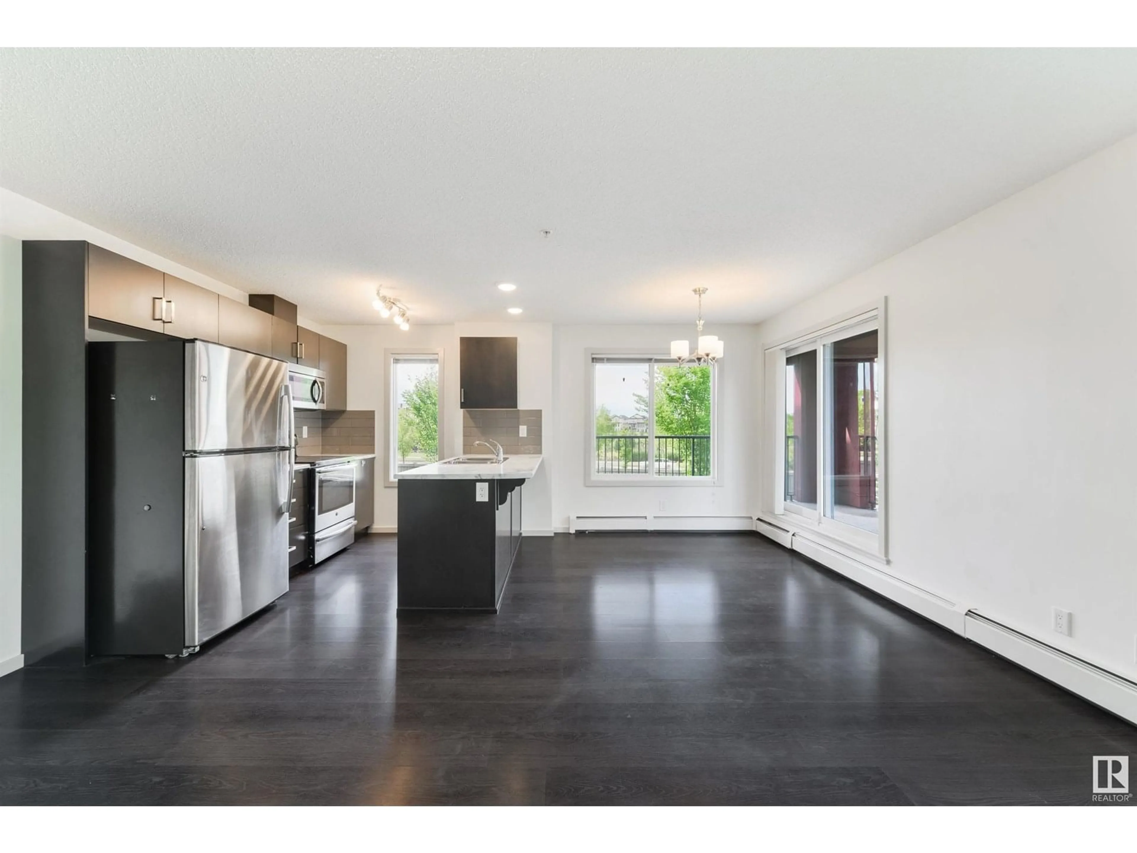 Open concept kitchen, wood/laminate floor for 202 - 5521 7 AV, Edmonton Alberta T6X2A8